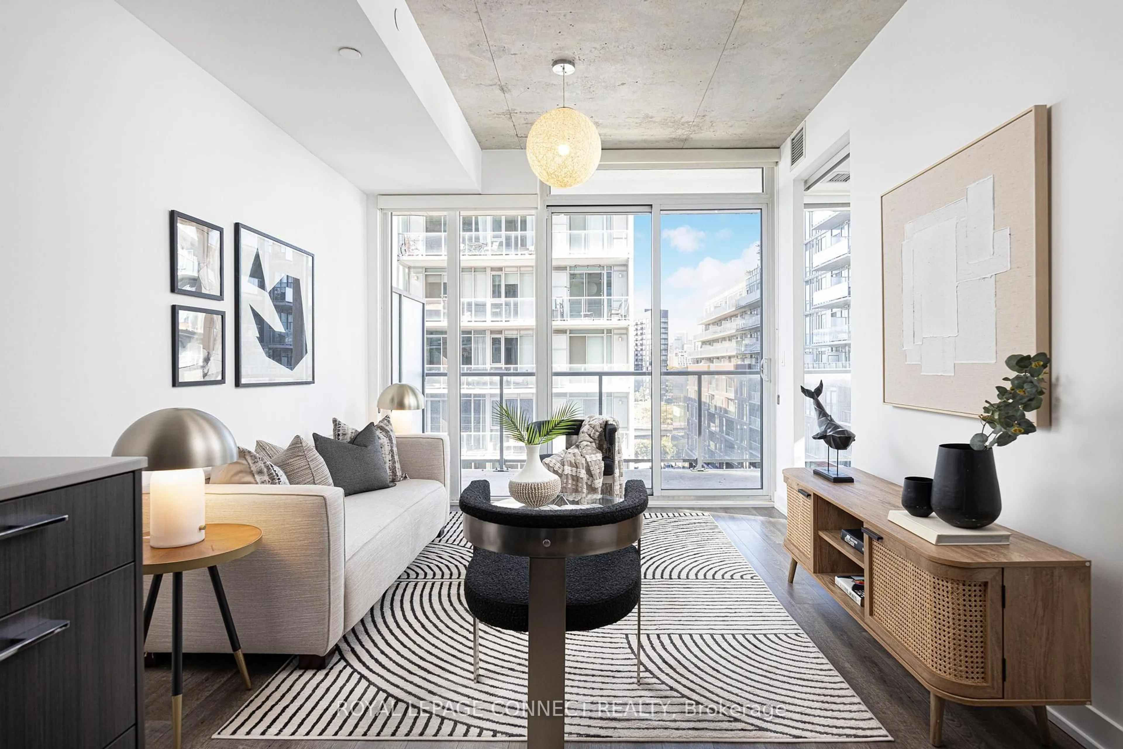 Living room with furniture, cement floor for 25 Baseball Pl #710, Toronto Ontario M4M 0E7