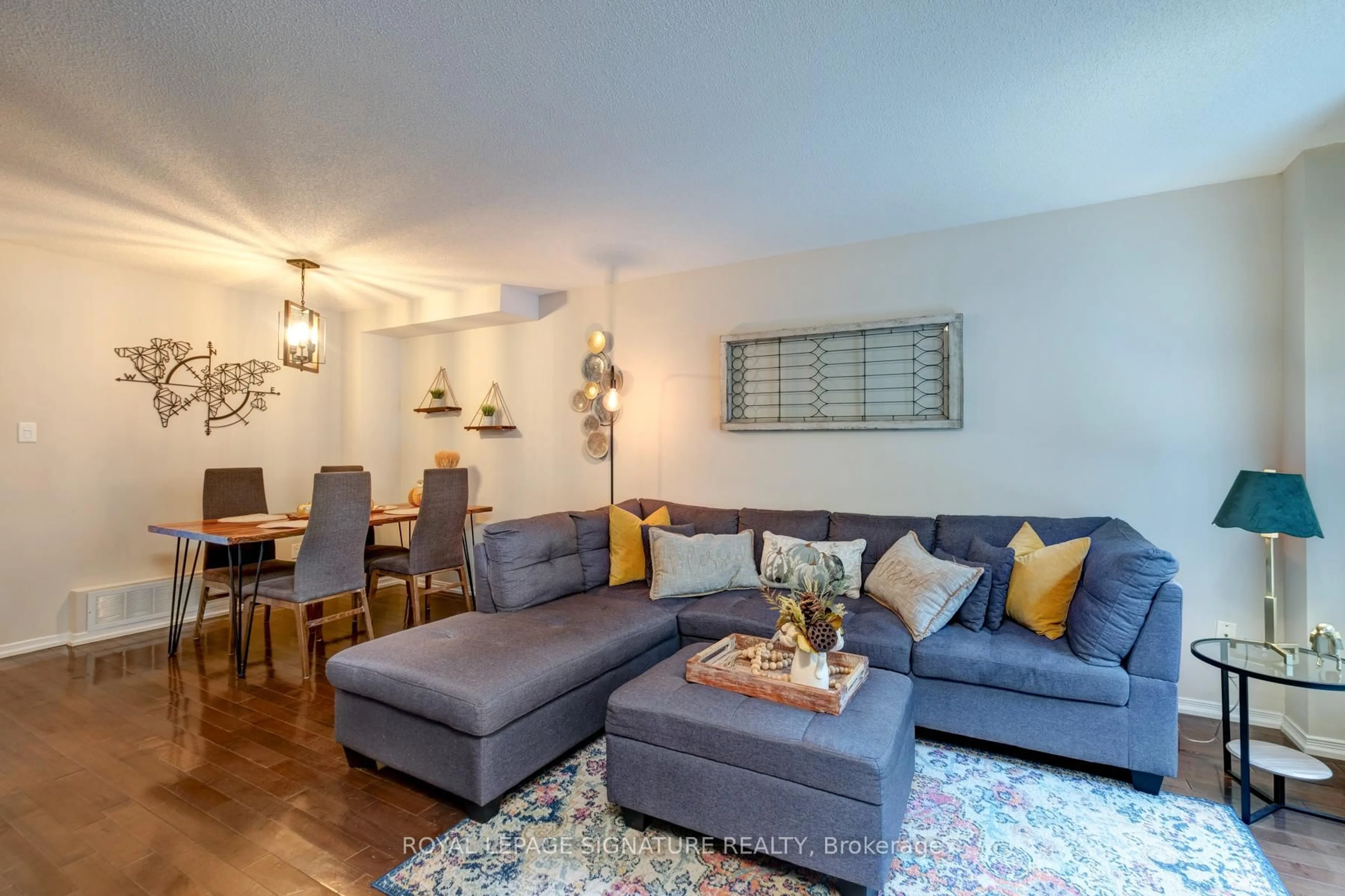 Living room with furniture, wood/laminate floor for 21 Trent Ave, Toronto Ontario M4C 5C6
