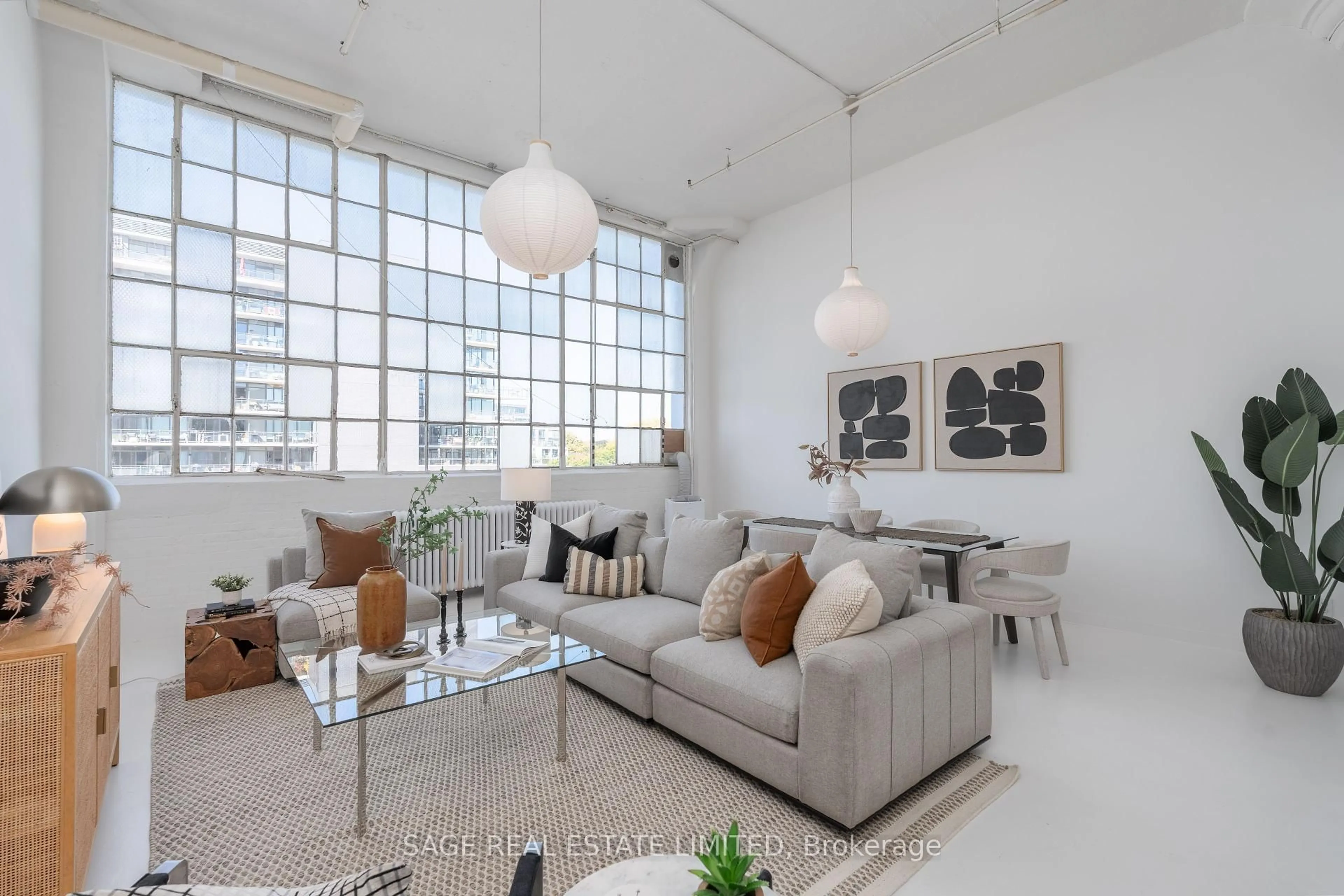 Living room with furniture, cement floor for 245 Carlaw Ave #403, Toronto Ontario M4M 2S1