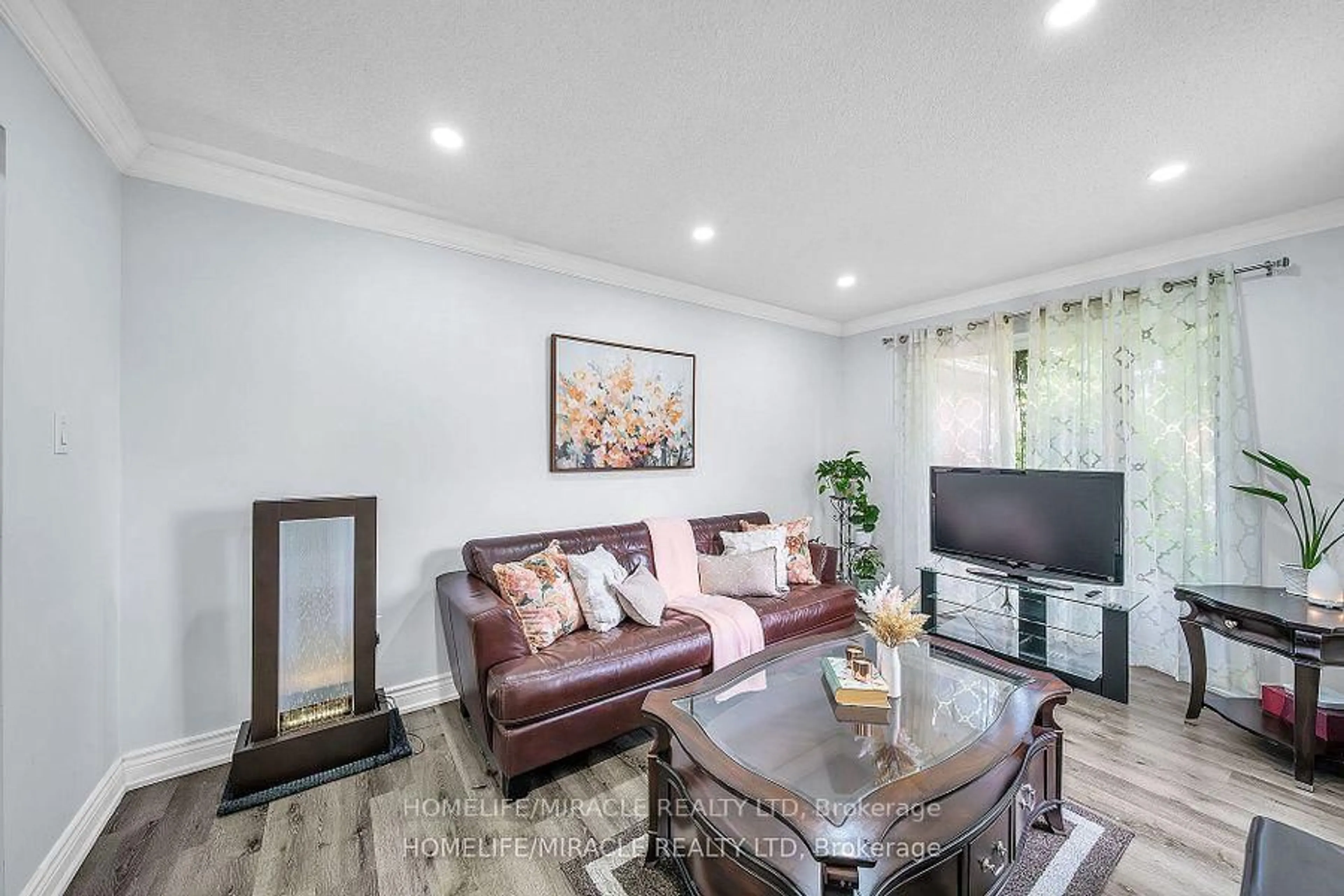 Living room with furniture, wood/laminate floor for 7 Houghton Crt, Whitby Ontario L1N 8G9