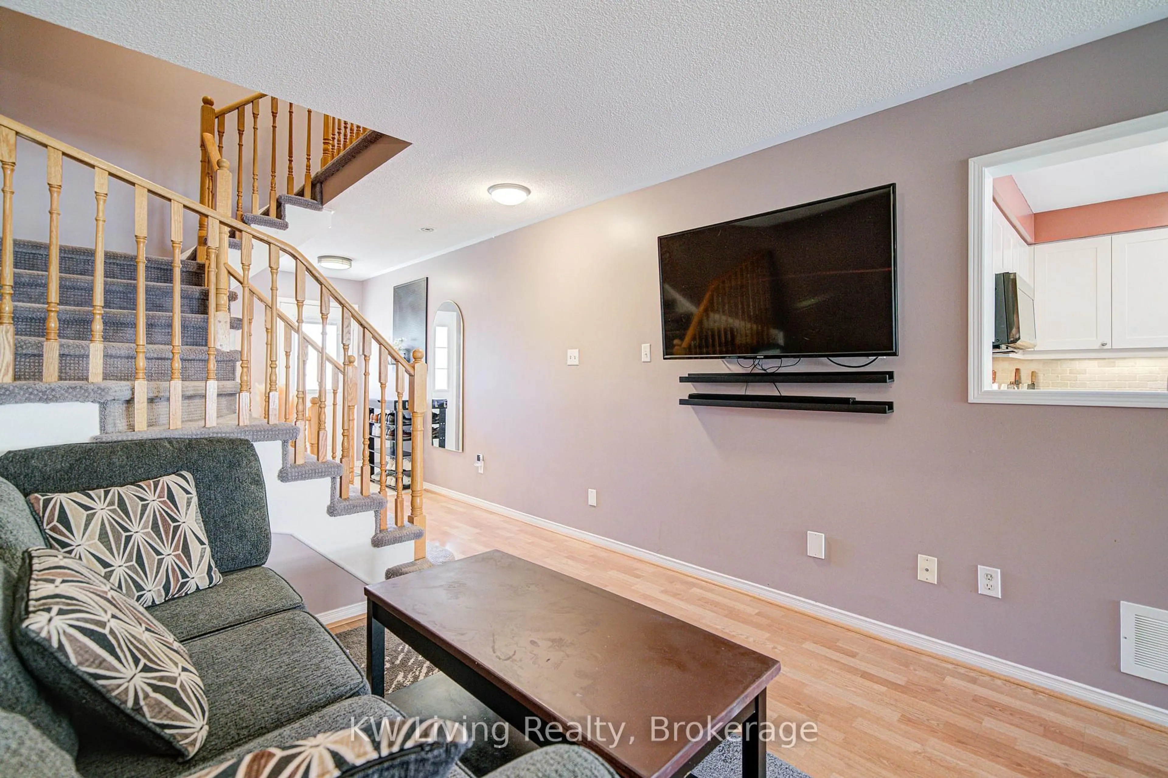 Living room with furniture, wood/laminate floor for 52 Moorefield Dr, Toronto Ontario M1C 5B6