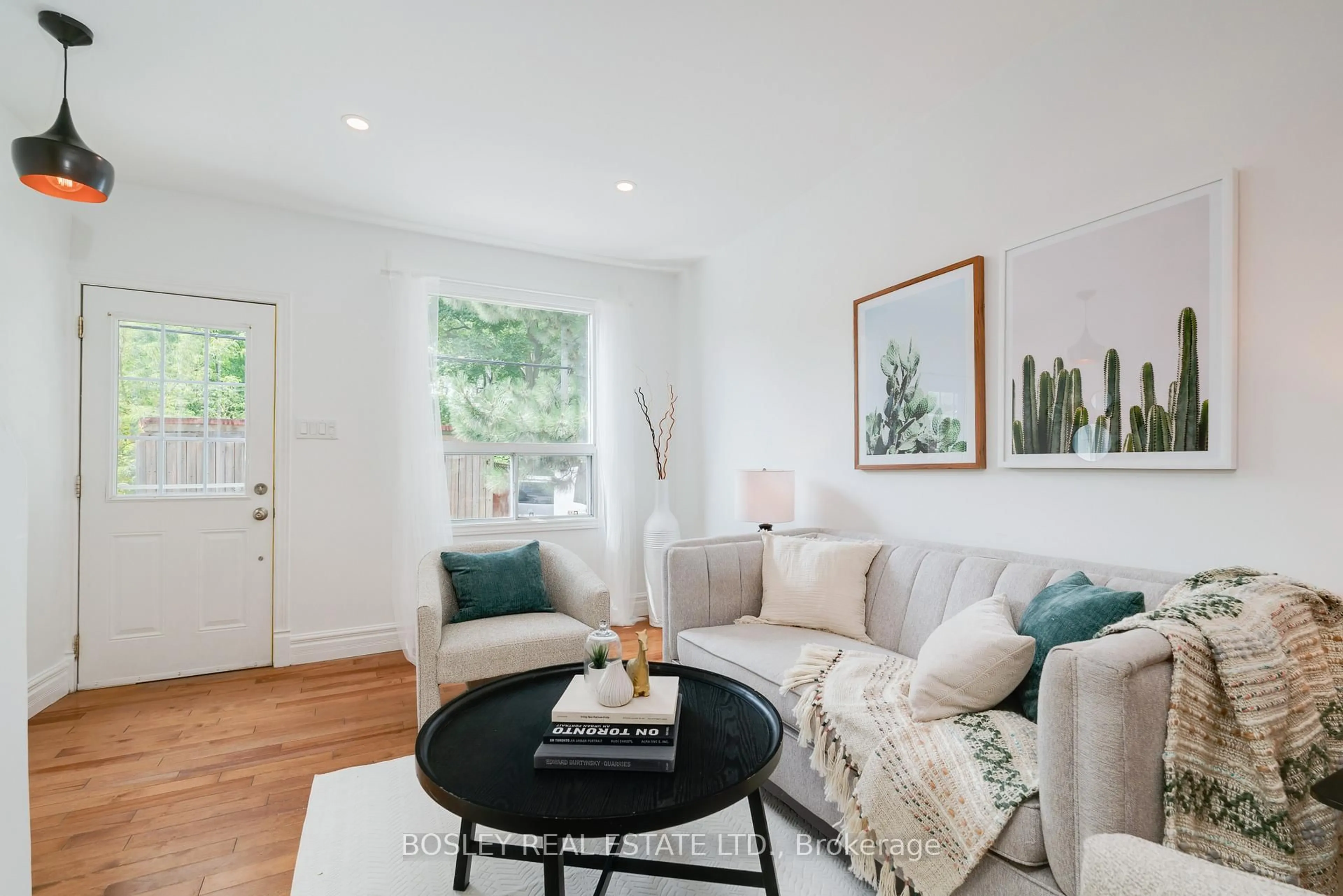 Living room with furniture, wood/laminate floor for 1057 Craven Rd, Toronto Ontario M4J 4V7