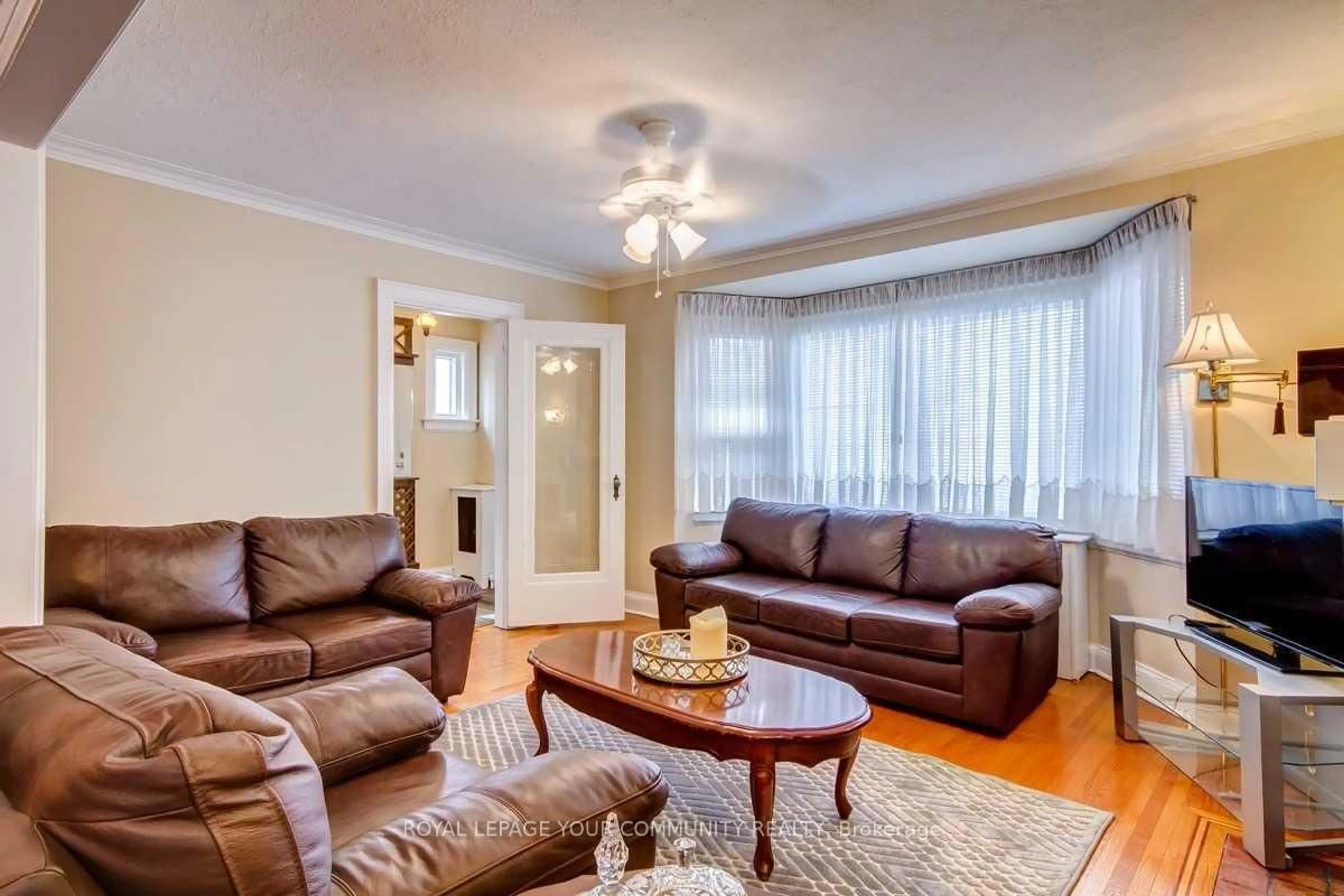 Living room with furniture, wood/laminate floor for 203 Woodycrest Ave, Toronto Ontario M4J 3C4