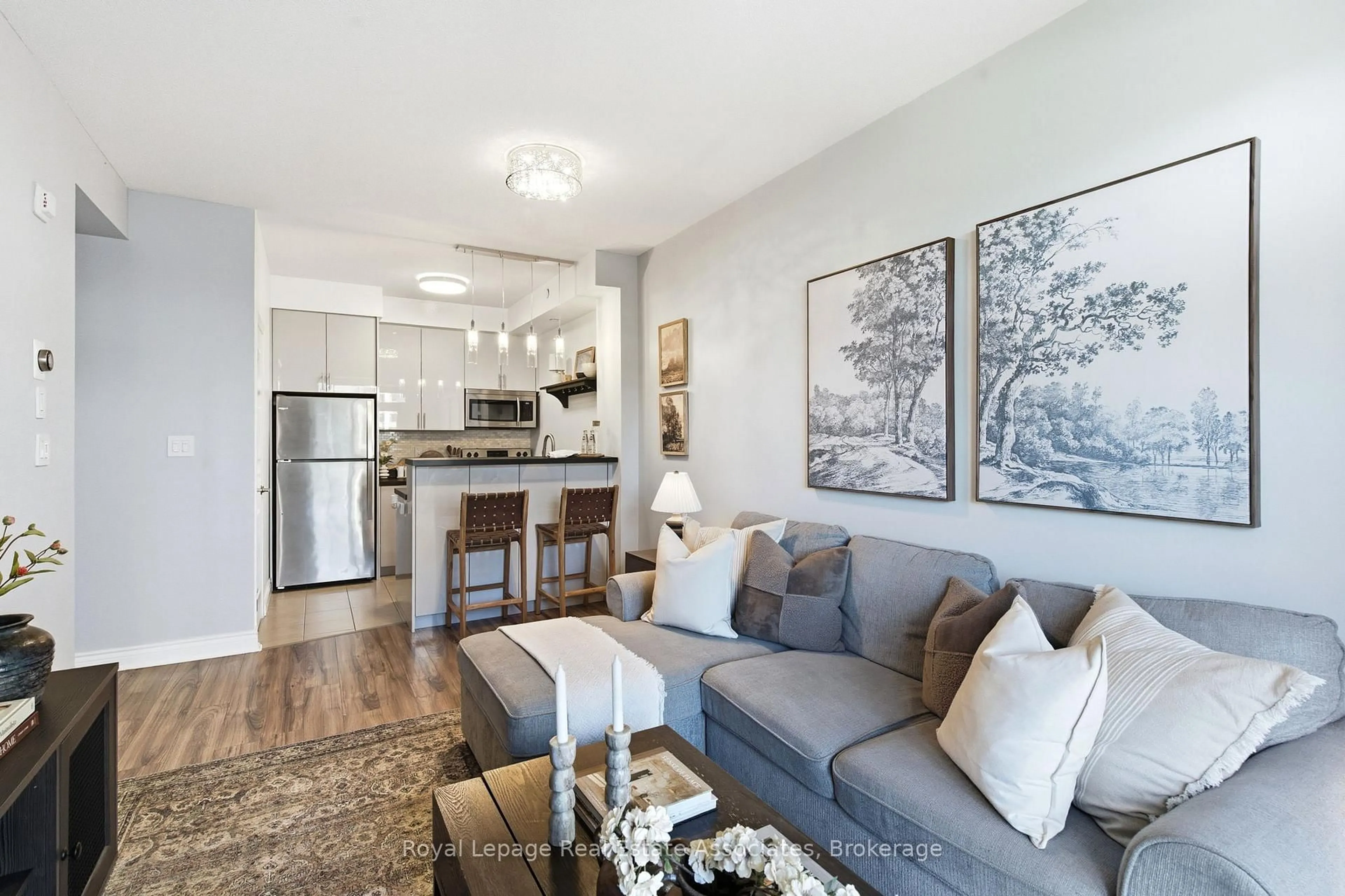Living room with furniture, wood/laminate floor for 80 Aspen Springs Dr #208, Clarington Ontario L1C 0V4