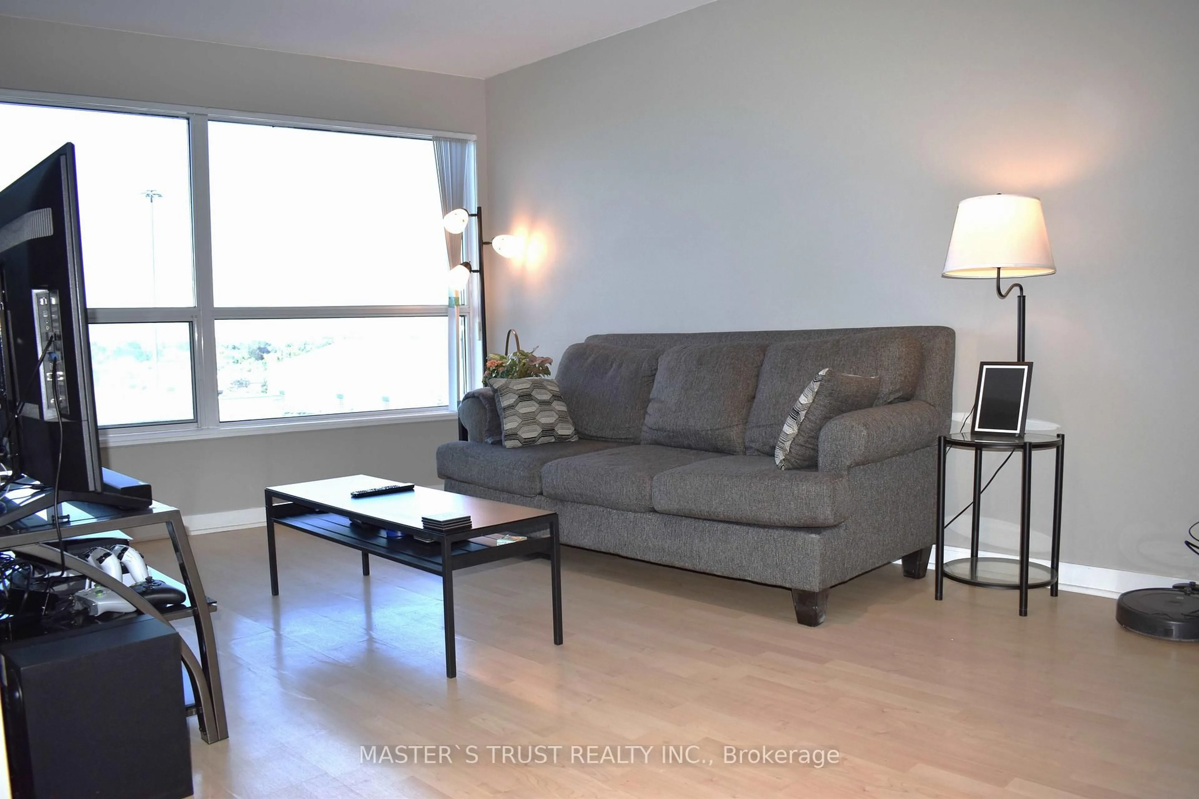 Living room with furniture, wood/laminate floor for 36 Lee Centre Dr #702, Toronto Ontario M1H 3J1