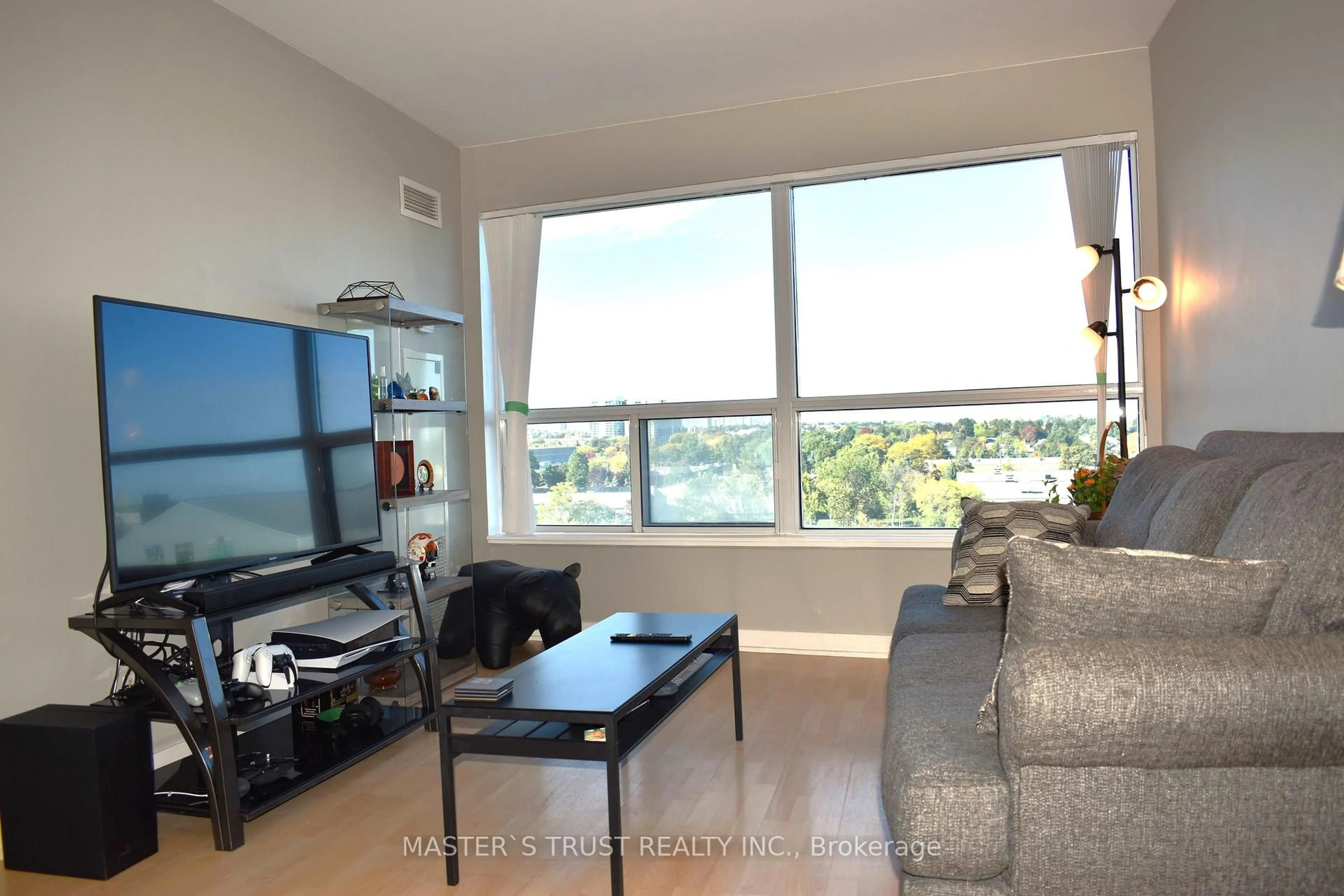 Living room with furniture, wood/laminate floor for 36 Lee Centre Dr #702, Toronto Ontario M1H 3J1