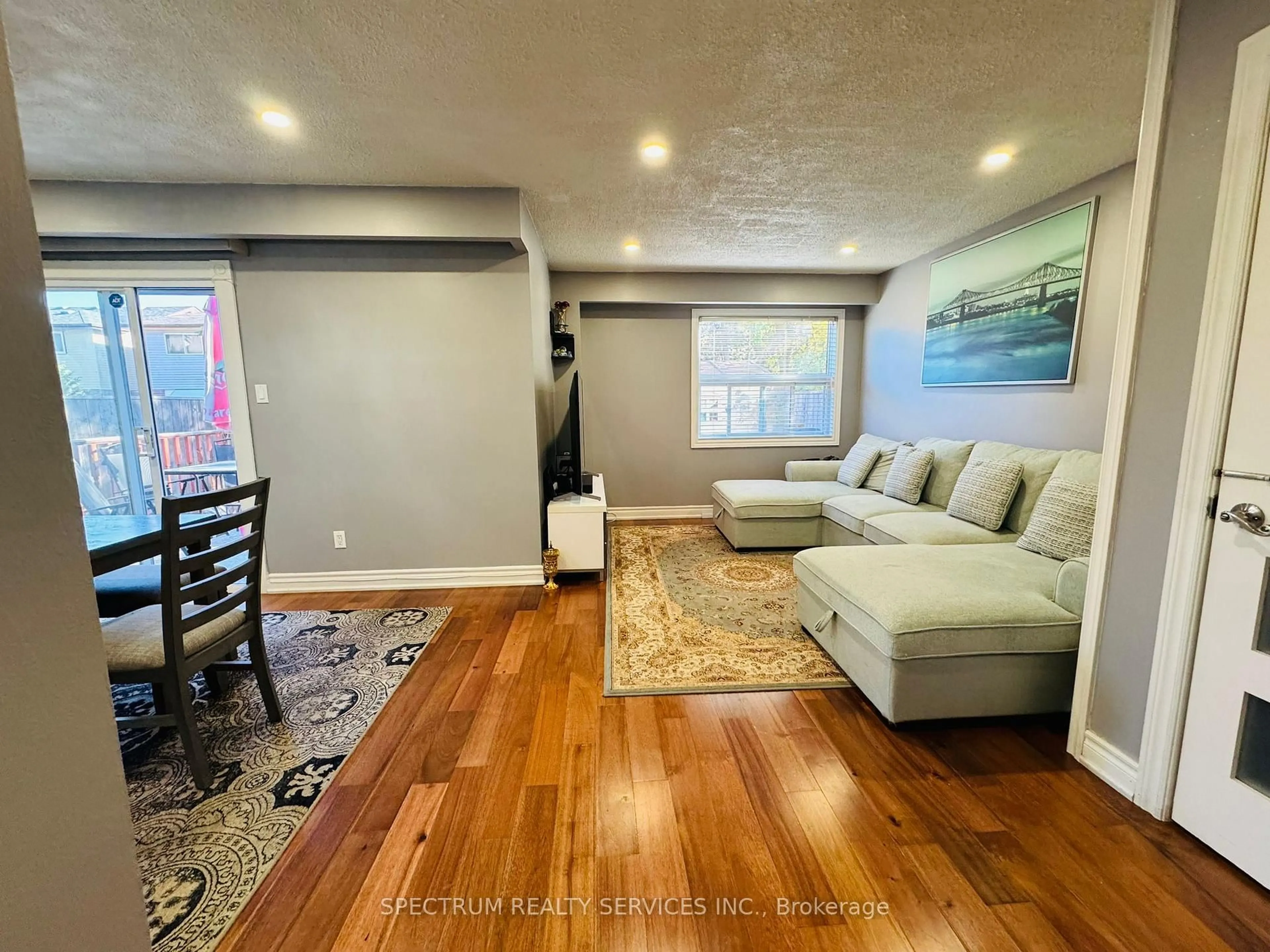 Living room with furniture, wood/laminate floor for 43 Mammoth Hall Tr, Toronto Ontario M1B 1P5