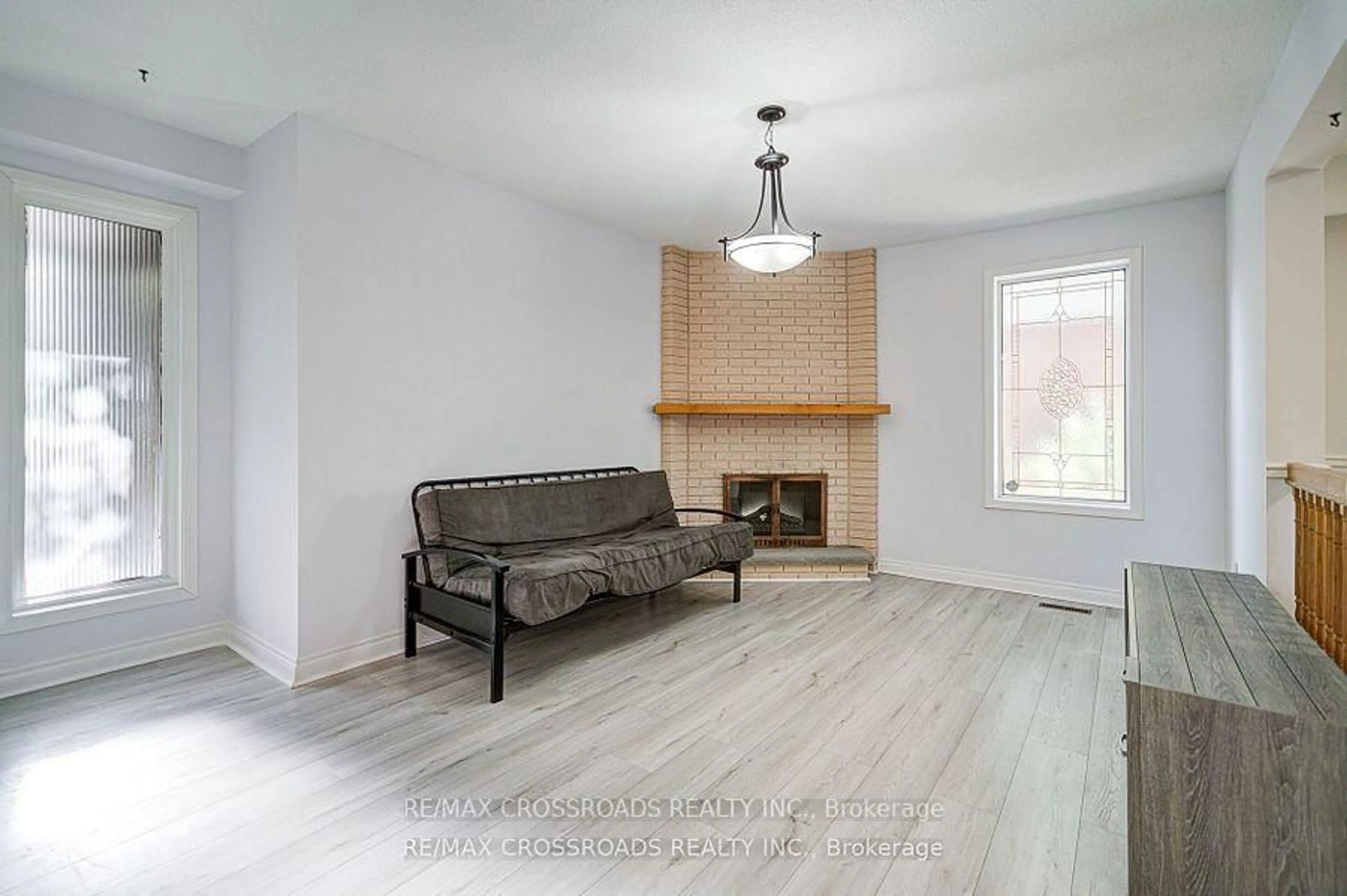 Living room with furniture, wood/laminate floor for 41 Huntsmill Blvd, Toronto Ontario M1W 2Z8