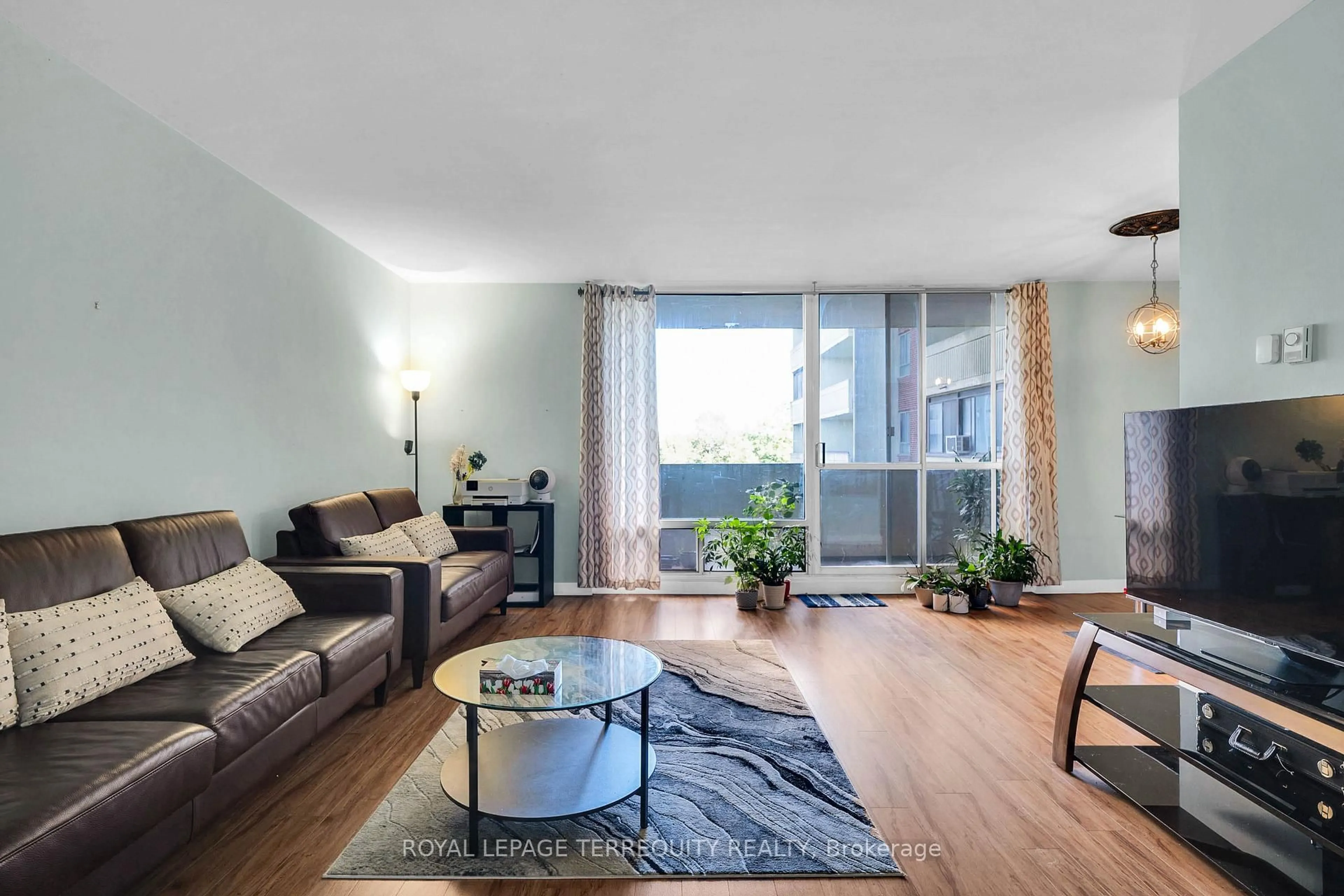 Living room with furniture, wood/laminate floor for 5 Massey Sq #519, Toronto Ontario M4C 5L6