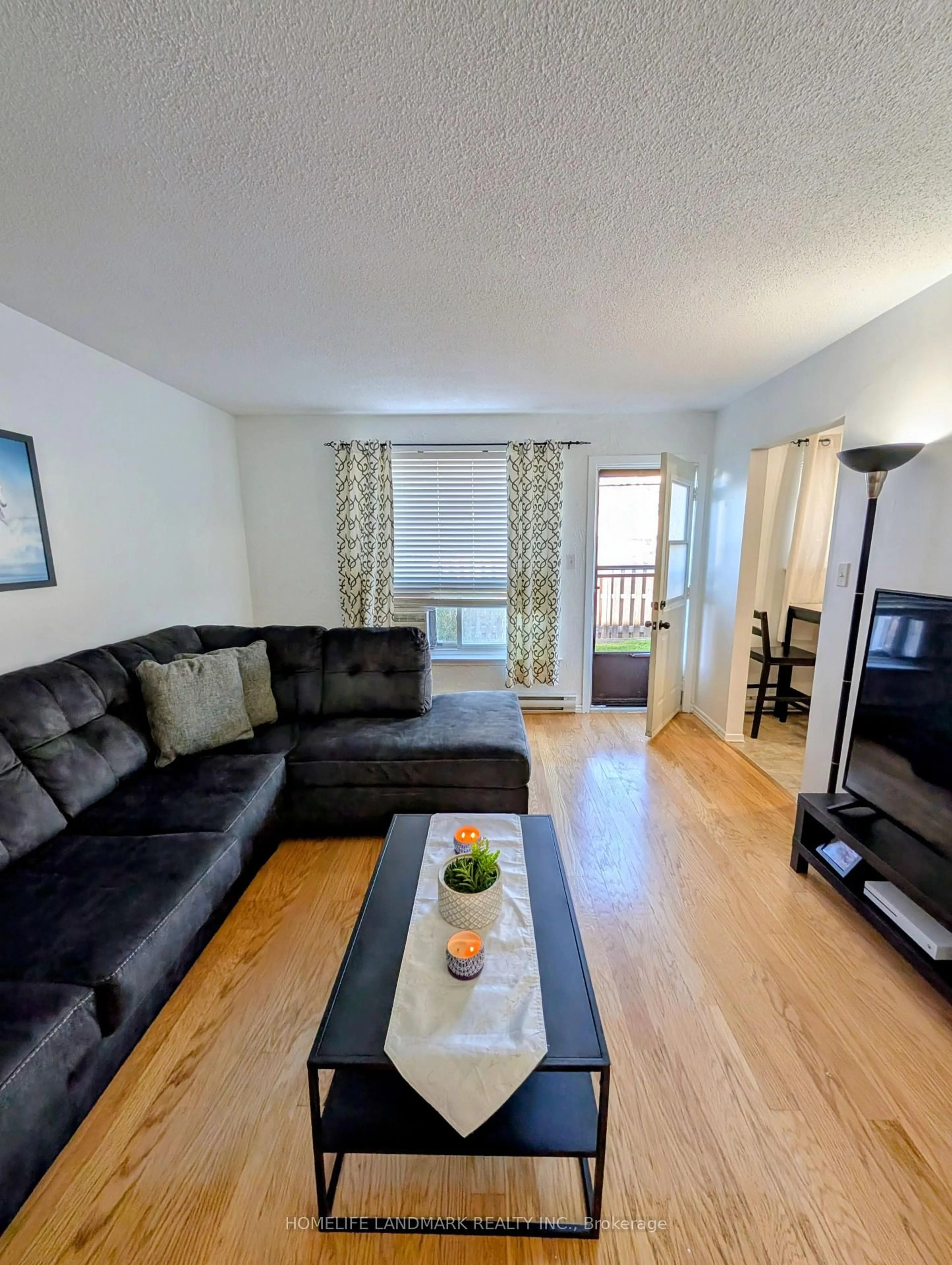 Living room with furniture, wood/laminate floor for 120 Nonquon Rd #15, Oshawa Ontario L1G 7E6