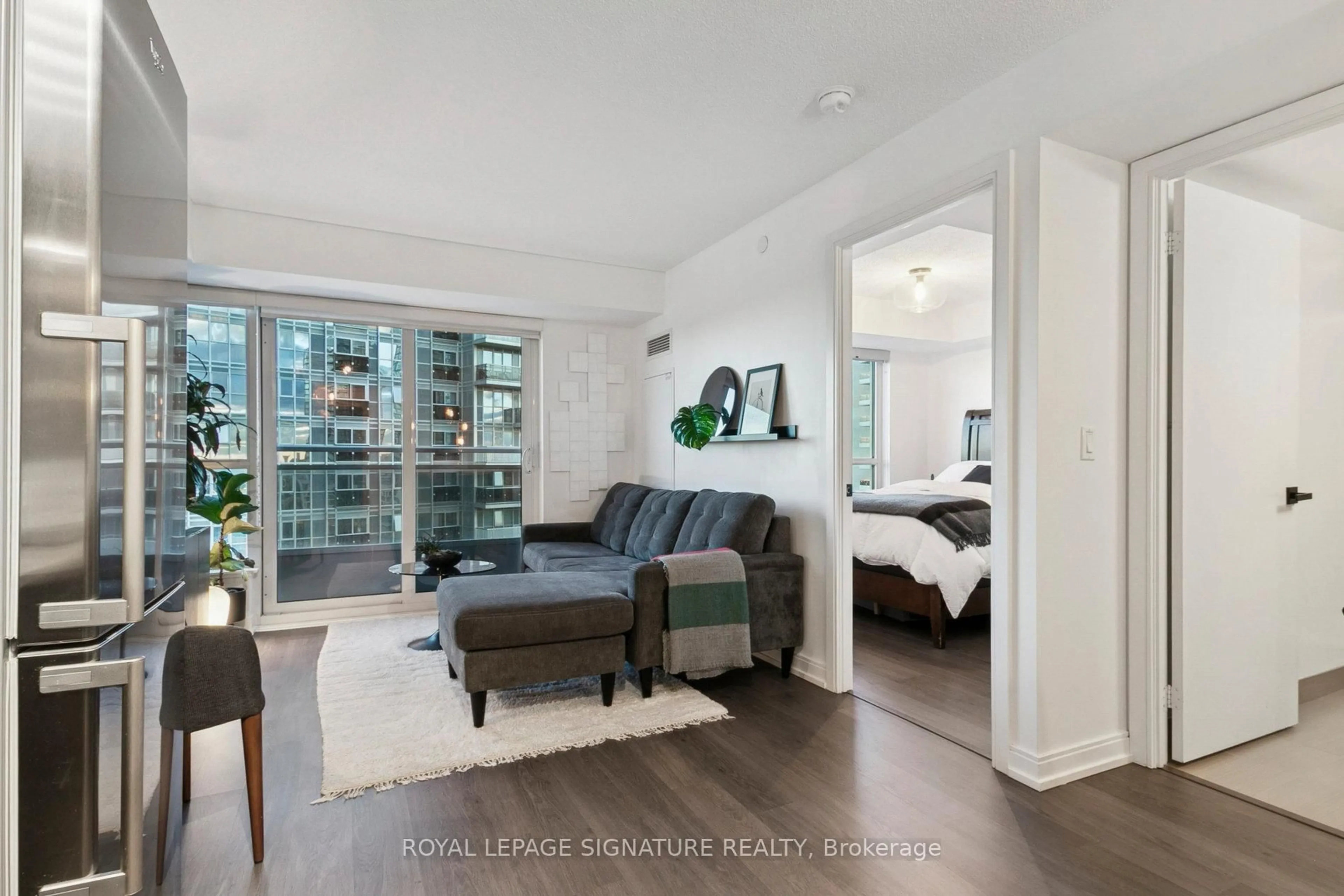 Living room with furniture, wood/laminate floor for 255 Village green Sq #1301, Toronto Ontario M1S 0L7