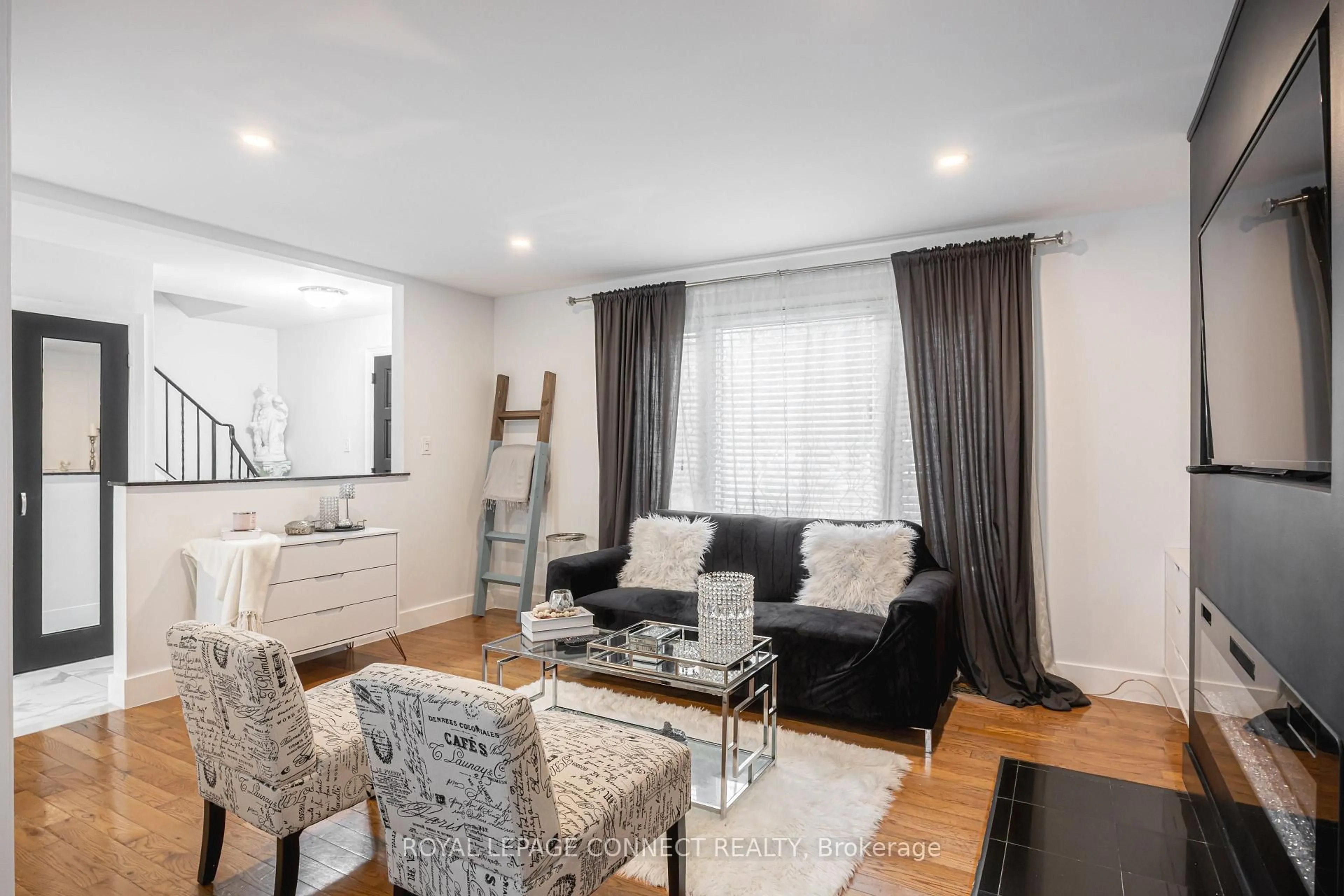 Living room with furniture, wood/laminate floor for 32 Harland Cres, Ajax Ontario L1S 1J9