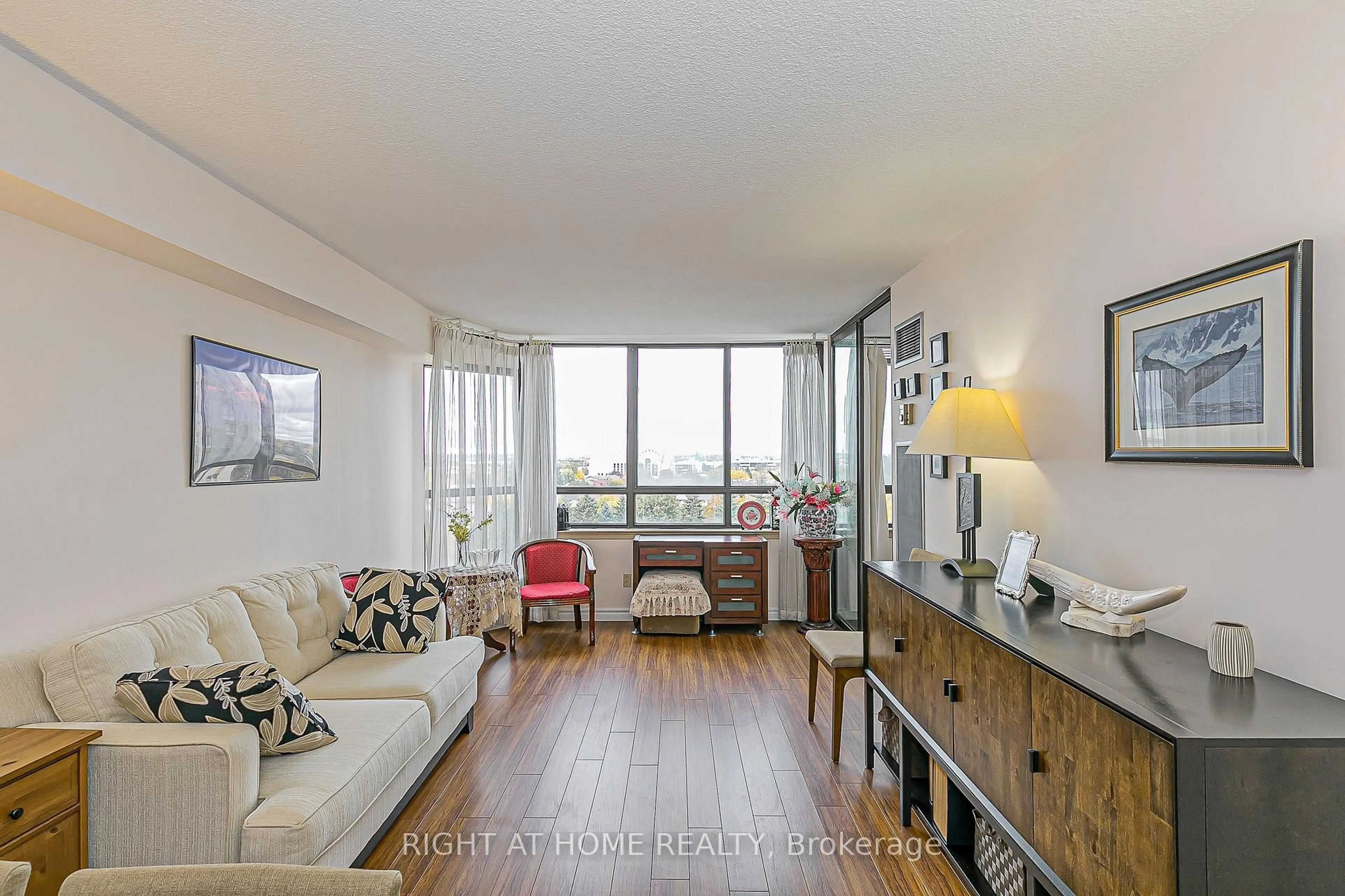 Living room with furniture, wood/laminate floor for 55 Bamburgh Circ #802, Toronto Ontario M1W 3V4