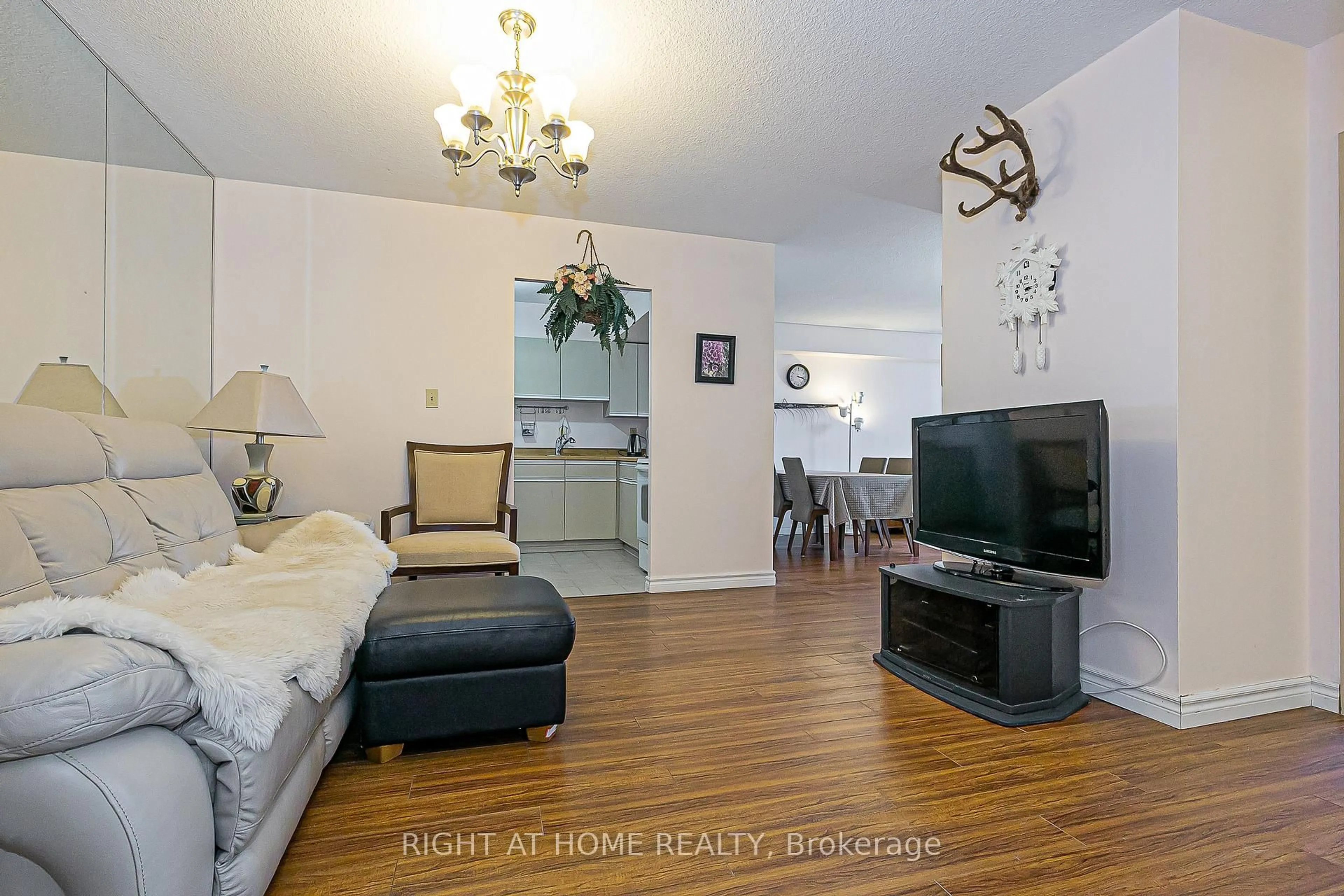 Living room with furniture, wood/laminate floor for 55 Bamburgh Circ #802, Toronto Ontario M1W 3V4