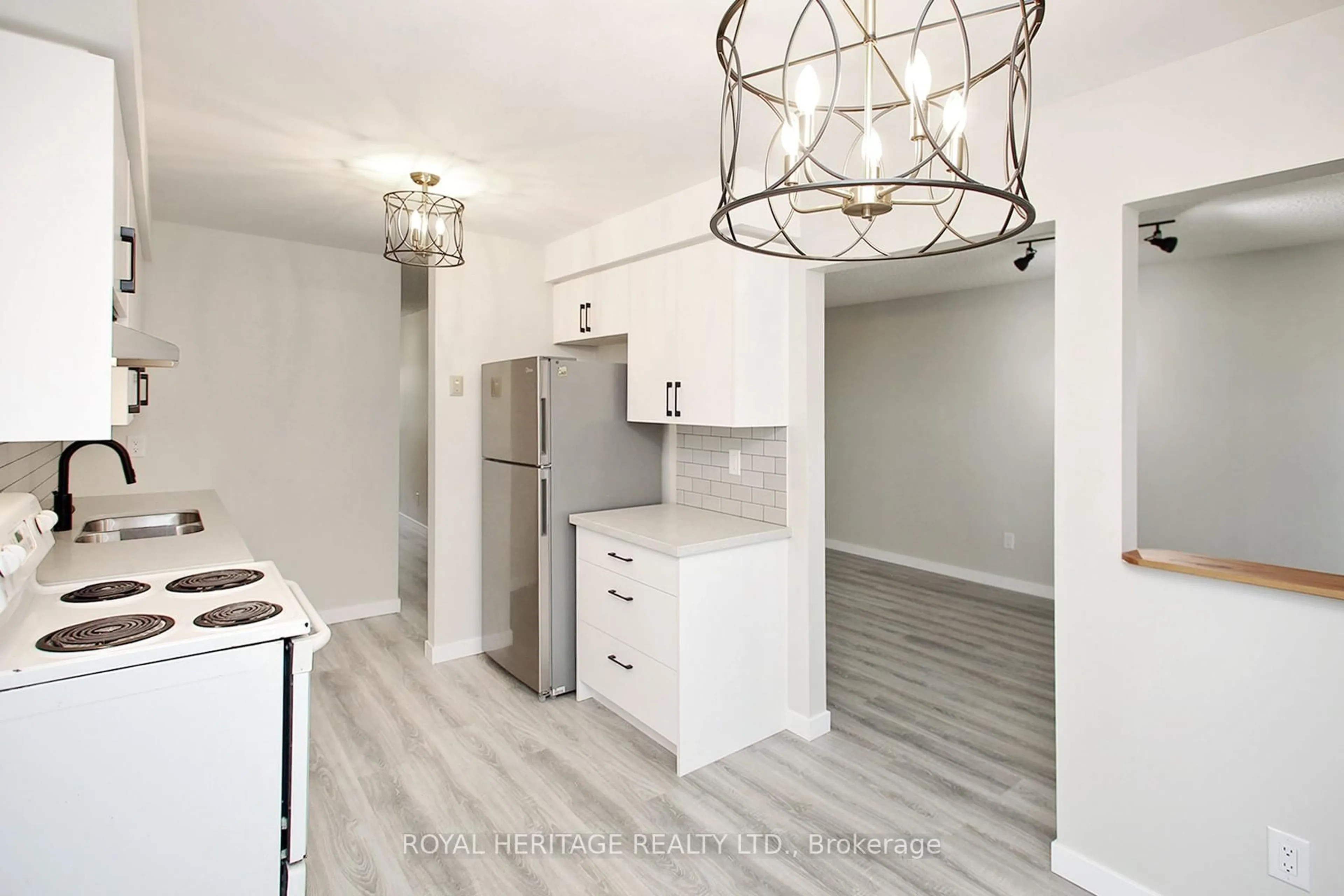 Open concept kitchen, wood/laminate floor for 27 Parker Cres, Ajax Ontario L1S 3R4