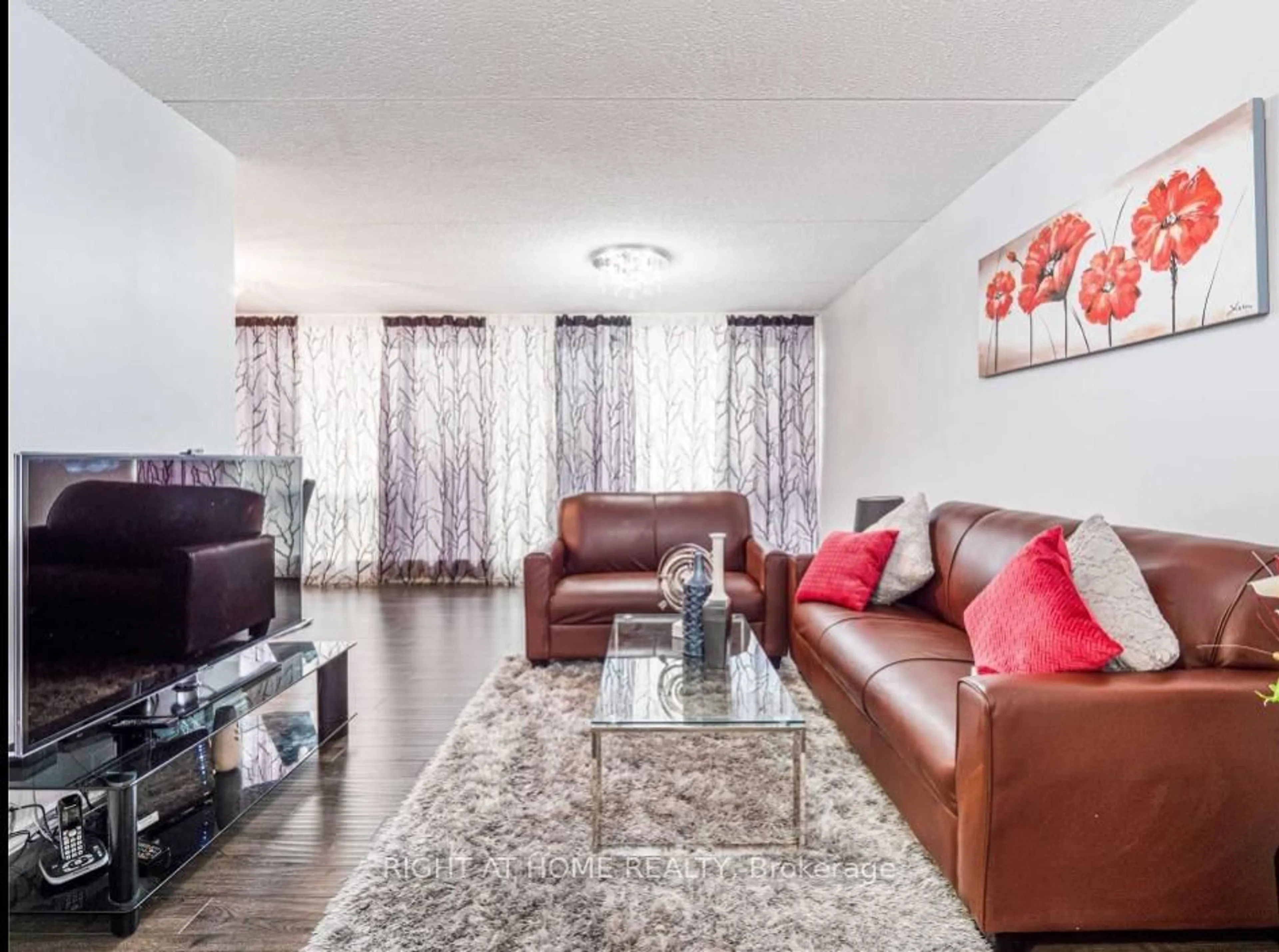 Living room with furniture, wood/laminate floor for 2 Glamorgan Ave #1104, Toronto Ontario M1P 2M8