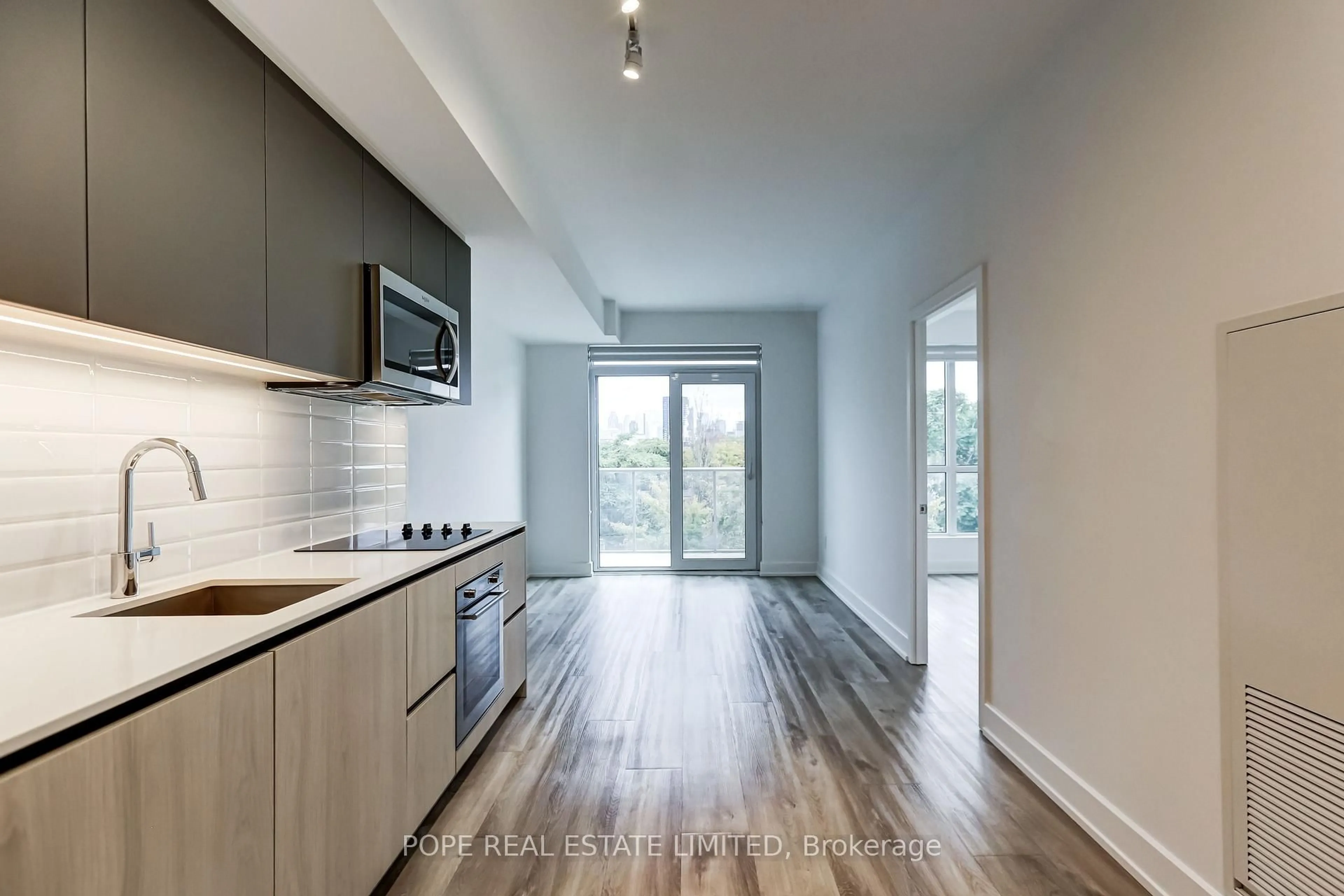Open concept kitchen, wood/laminate floor for 150 Logan Ave #509, Toronto Ontario M4M 0E4