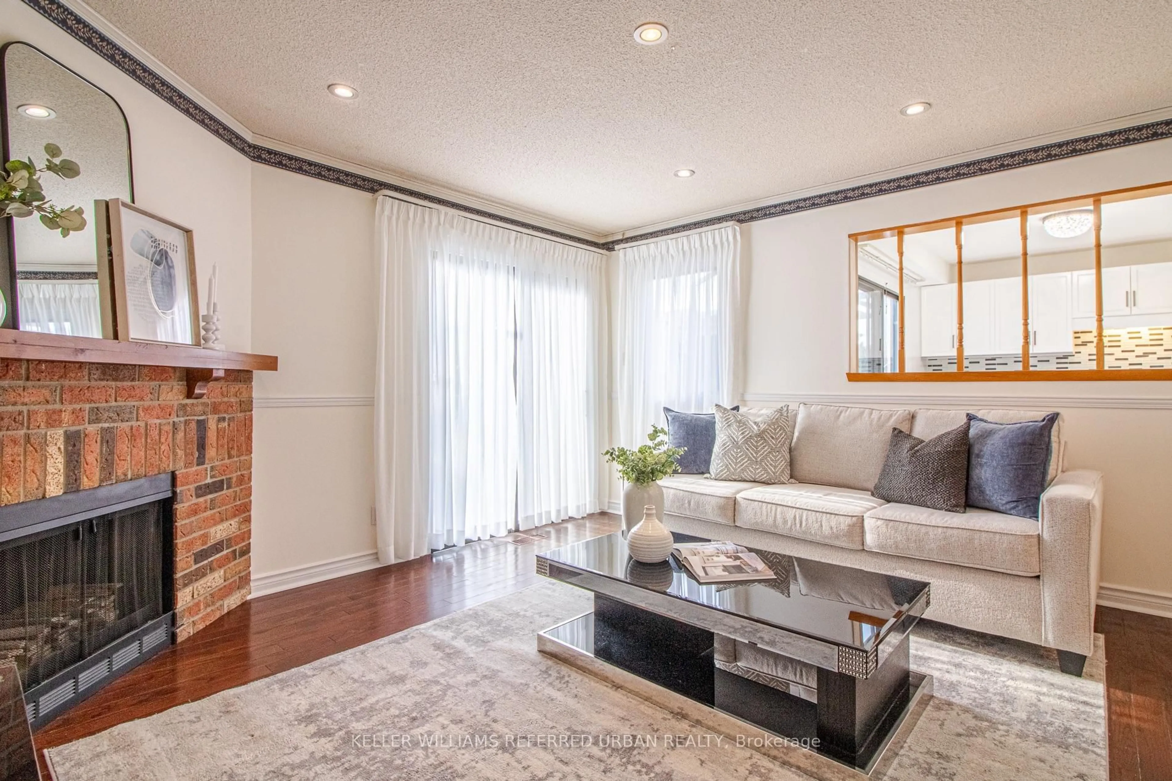 Living room with furniture, wood/laminate floor for 63 Holmbush Cres, Toronto Ontario M1V 2Y8