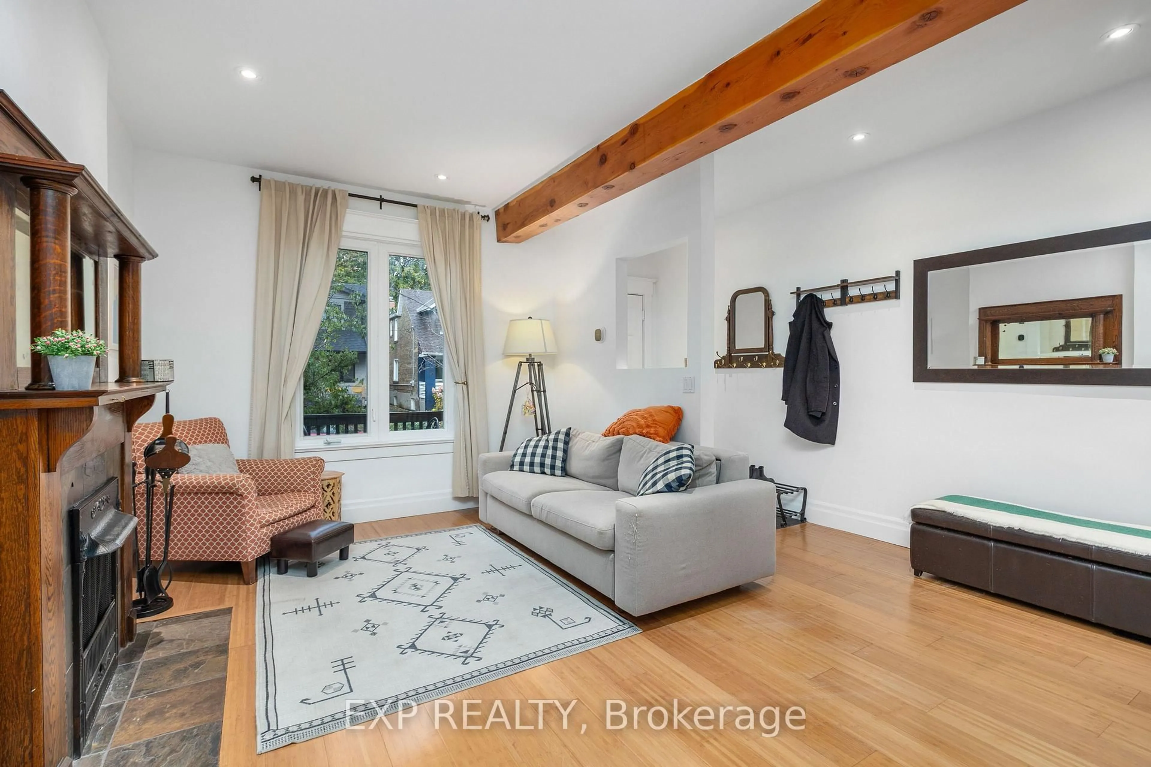 Living room with furniture, wood/laminate floor for 8 Bertmount Ave, Toronto Ontario M4M 2X9