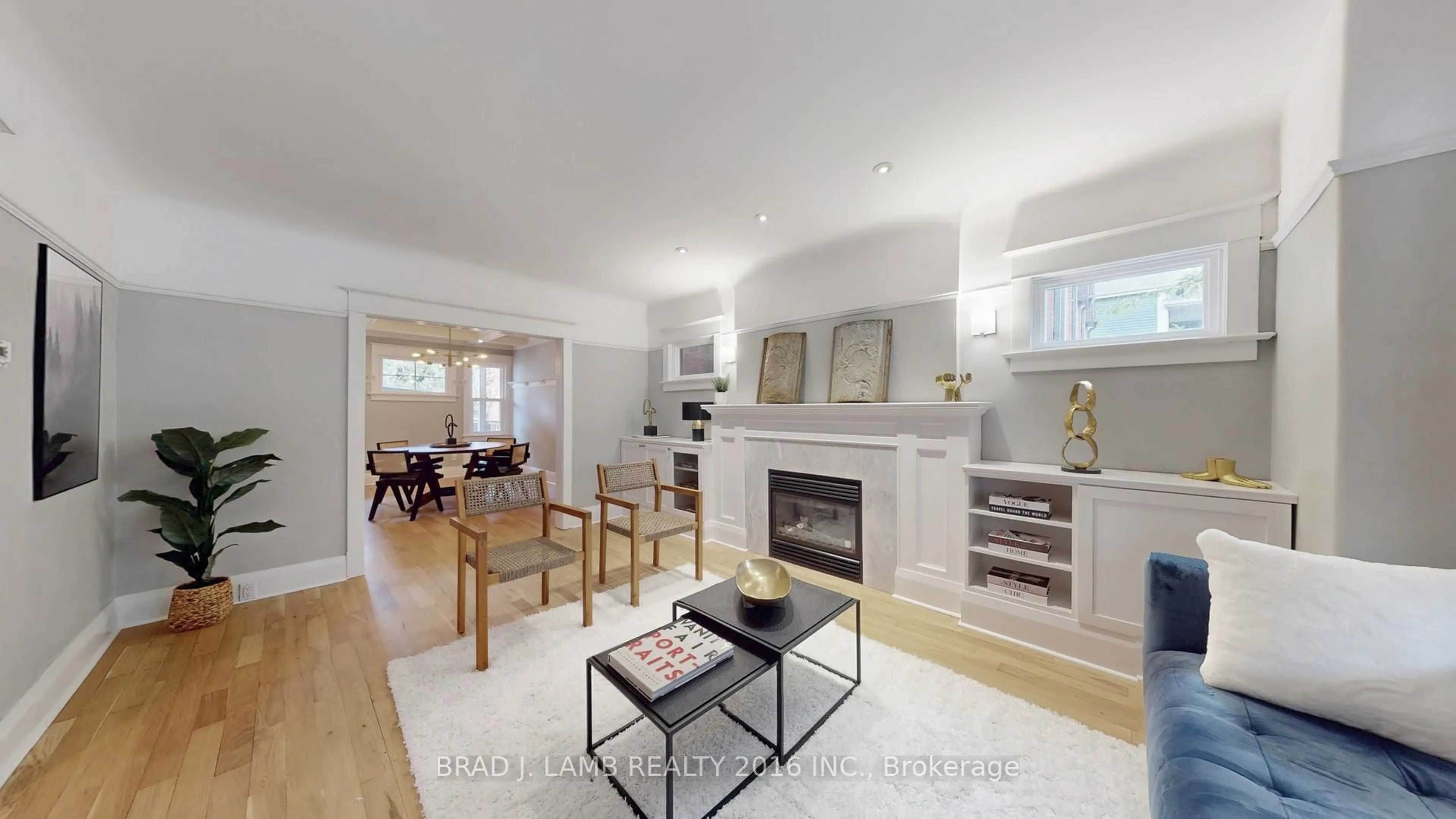 Living room with furniture, wood/laminate floor for 107 Woodbine Ave, Toronto Ontario M4L 3P1