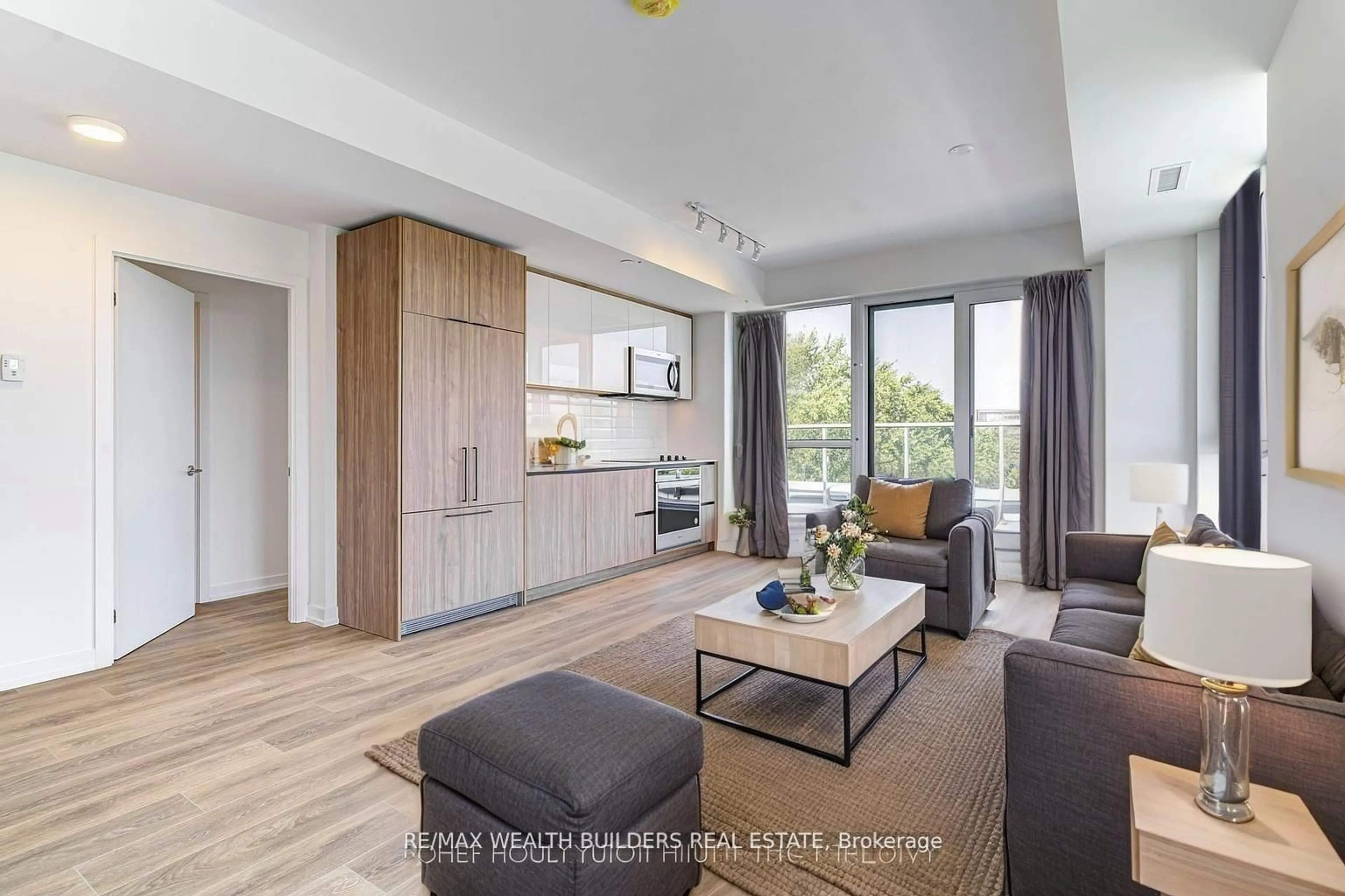 Living room with furniture, wood/laminate floor for 150 Logan Ave #627, Toronto Ontario M4M 0E4