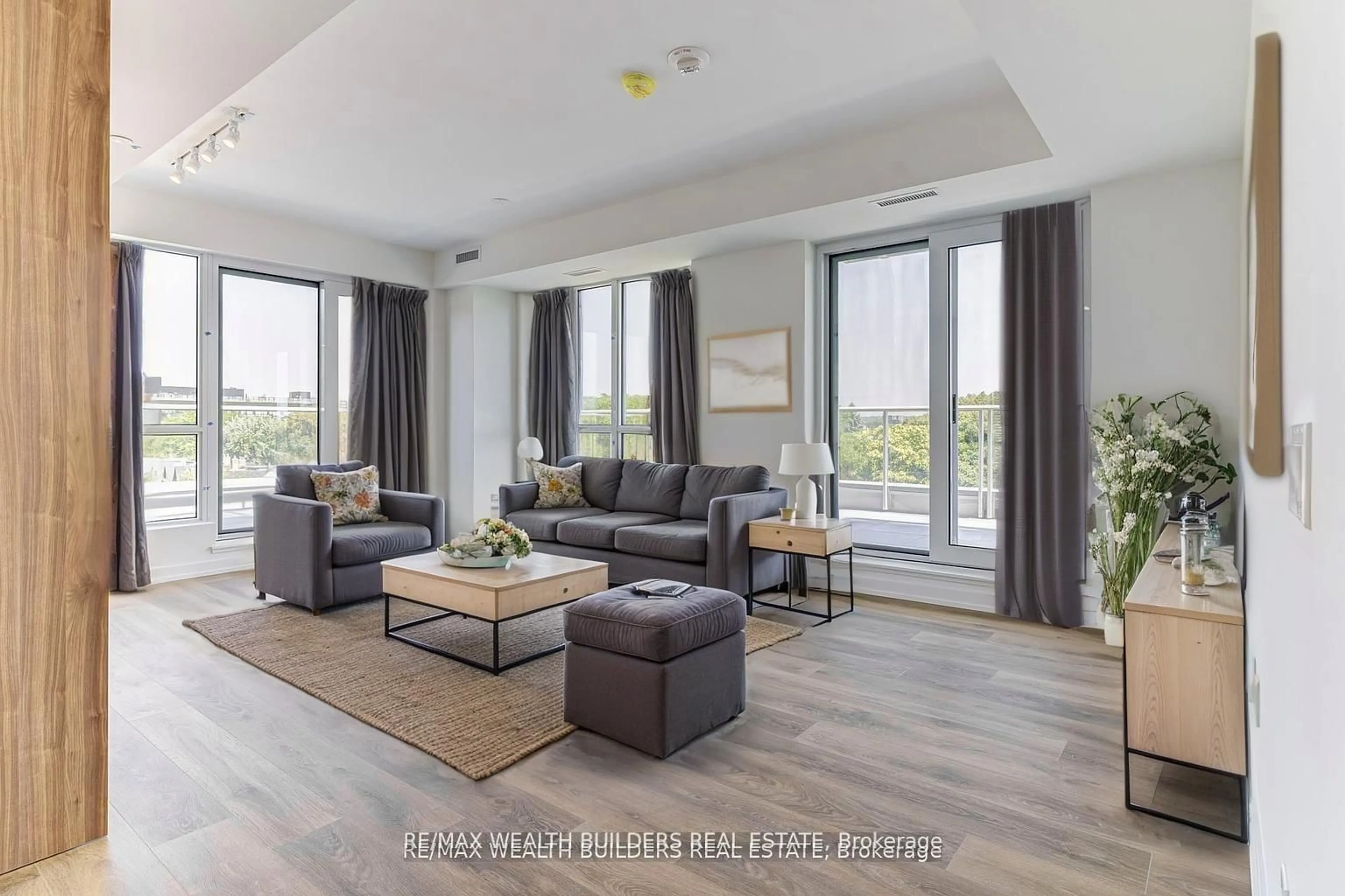 Living room with furniture, wood/laminate floor for 150 Logan Ave #627, Toronto Ontario M4M 0E4