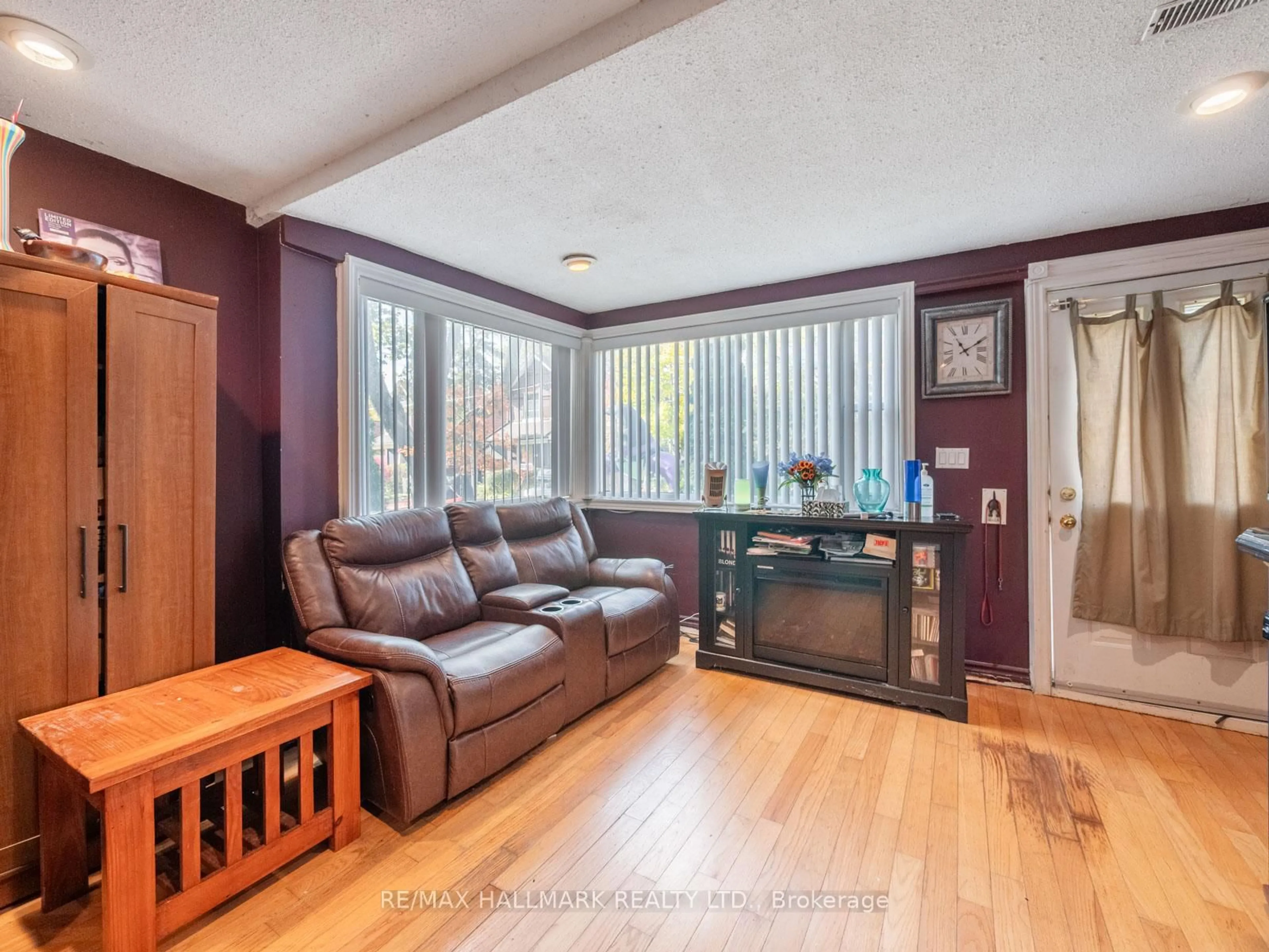 Living room with furniture, wood/laminate floor for 33 Earl Grey Rd, Toronto Ontario M4J 3L3