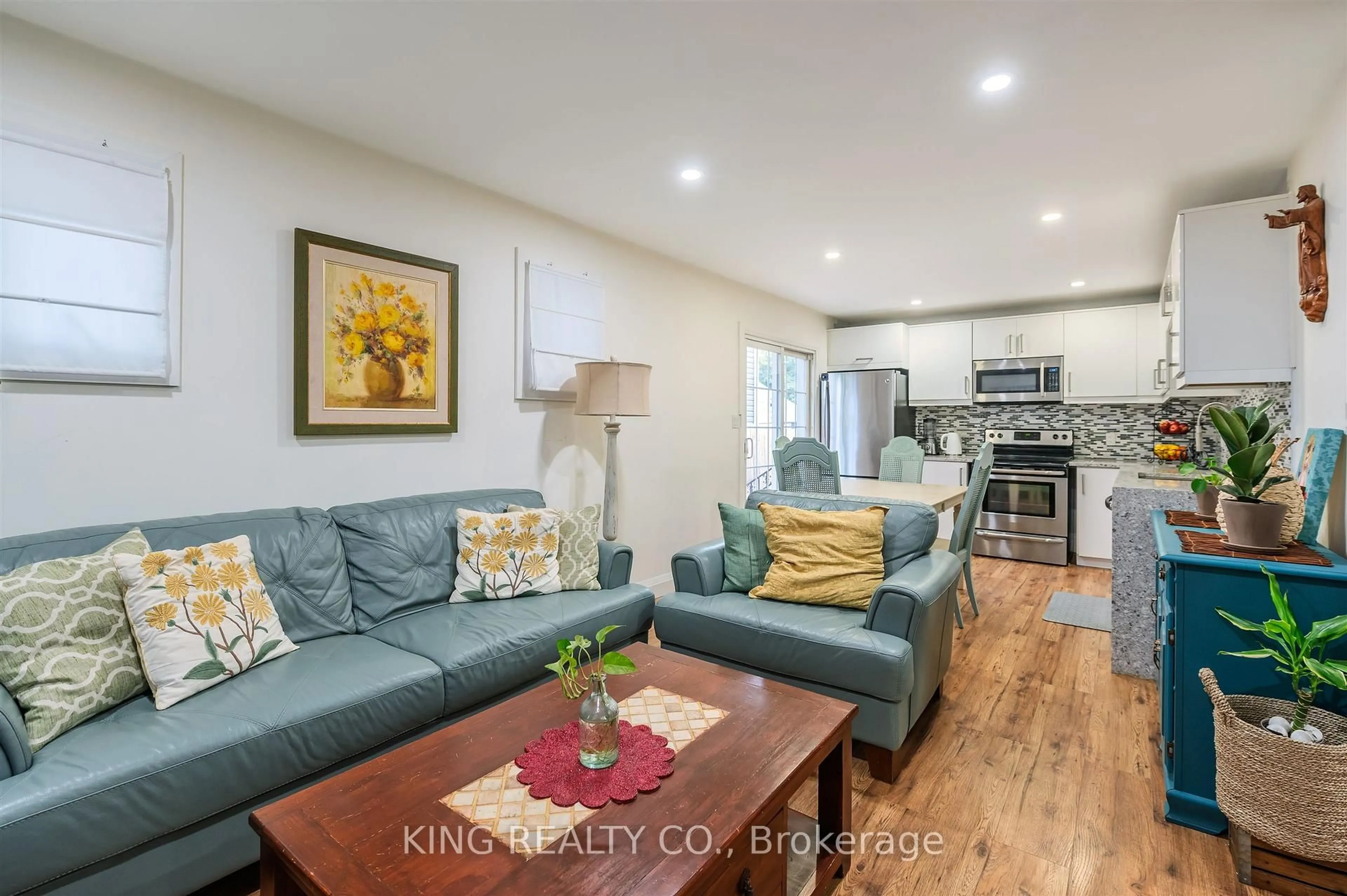 Living room with furniture, wood/laminate floor for 829 Athol St, Whitby Ontario L1N 4A1