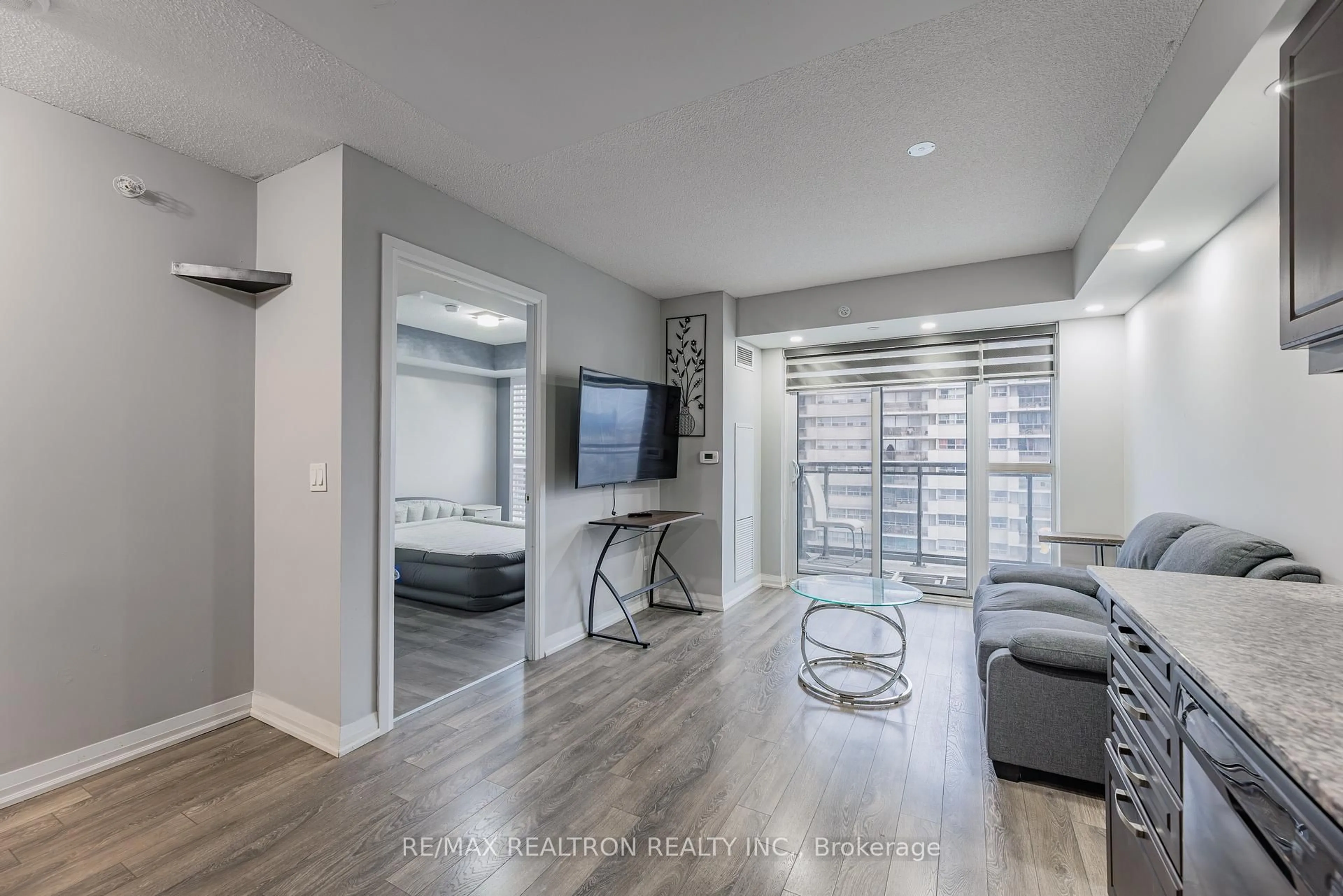 Living room with furniture, wood/laminate floor for 30 Meadowglen Pl #1403, Toronto Ontario M1G 0A6