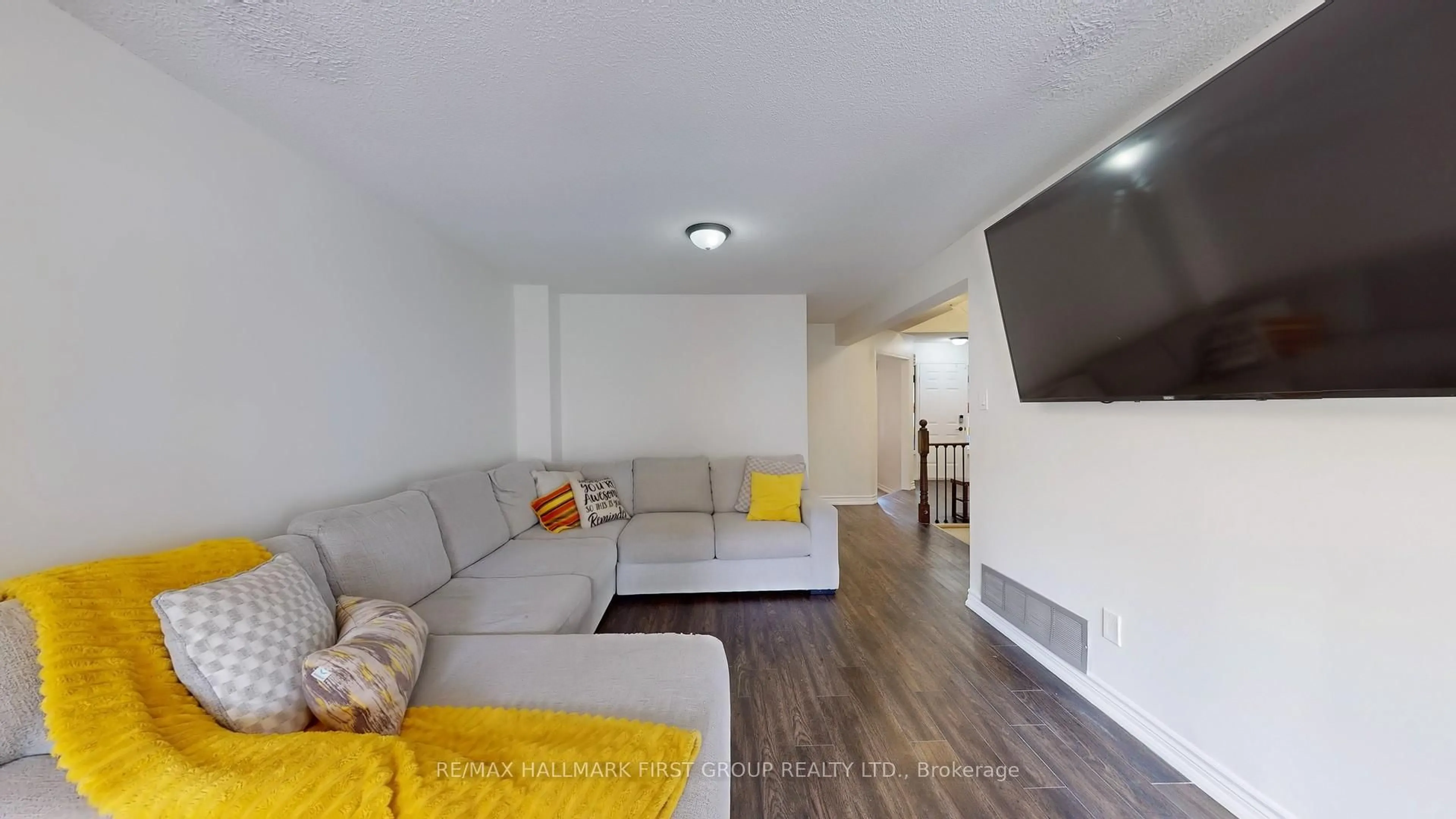 Living room with furniture, wood/laminate floor for 54 Davies Cres, Whitby Ontario L1N 8X5