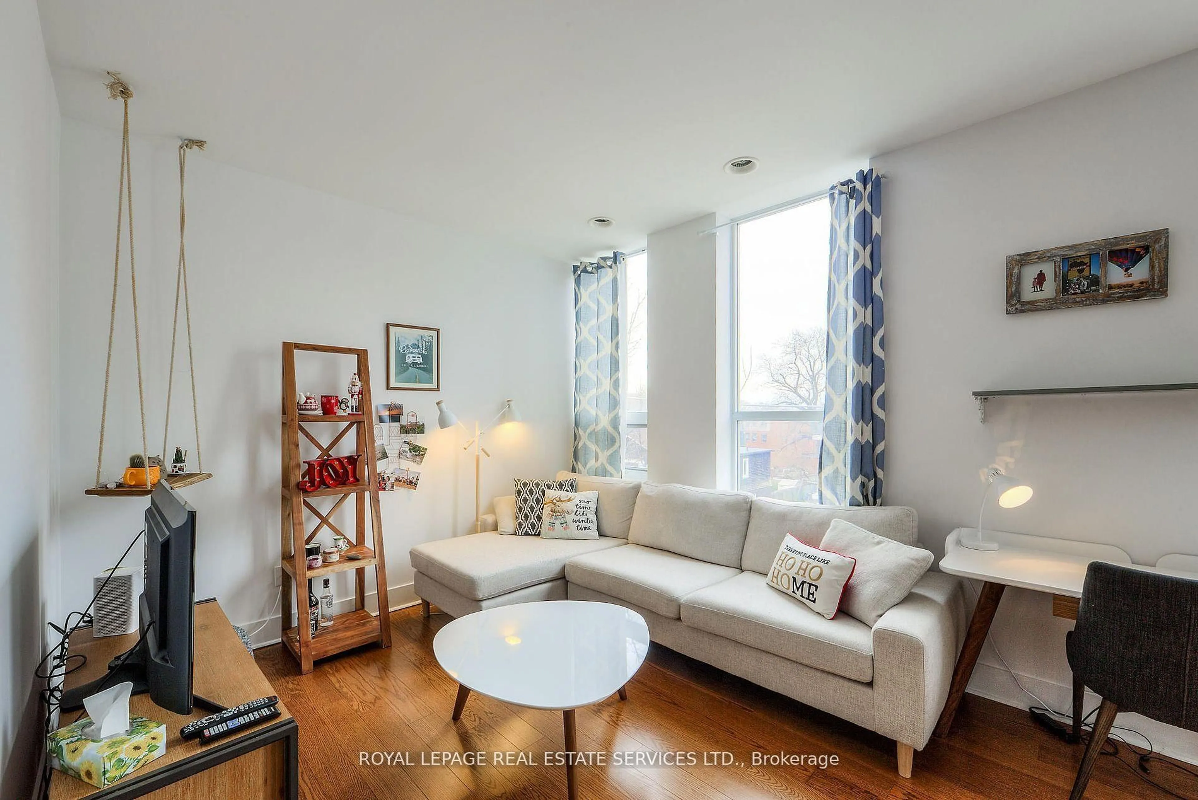 Living room with furniture, wood/laminate floor for 323 Kingston Rd #203, Toronto Ontario M4L 1T8