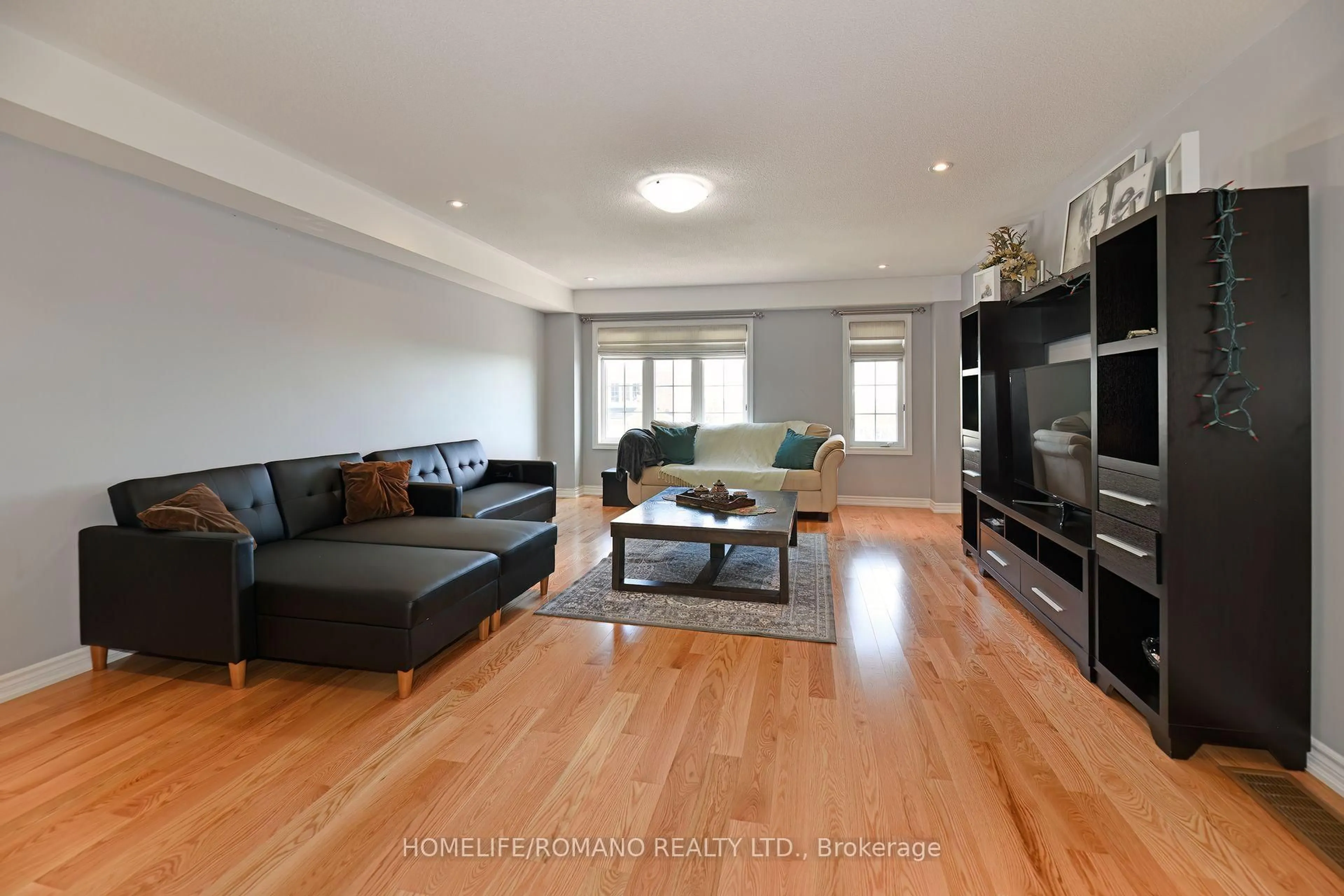 Living room with furniture, wood/laminate floor for 33 Comfort Way, Whitby Ontario L1N 2K6