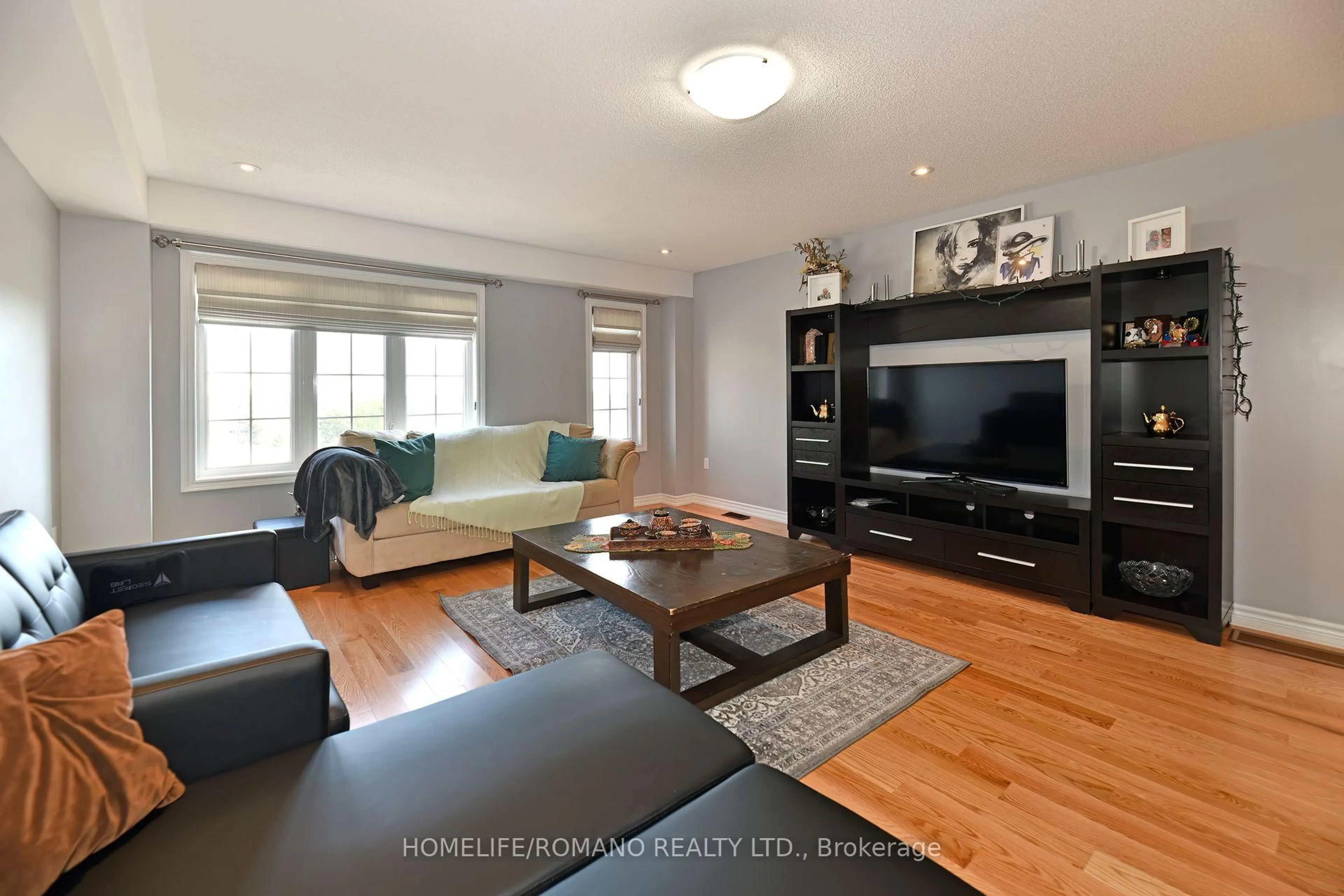 Living room with furniture, wood/laminate floor for 33 Comfort Way, Whitby Ontario L1N 2K6