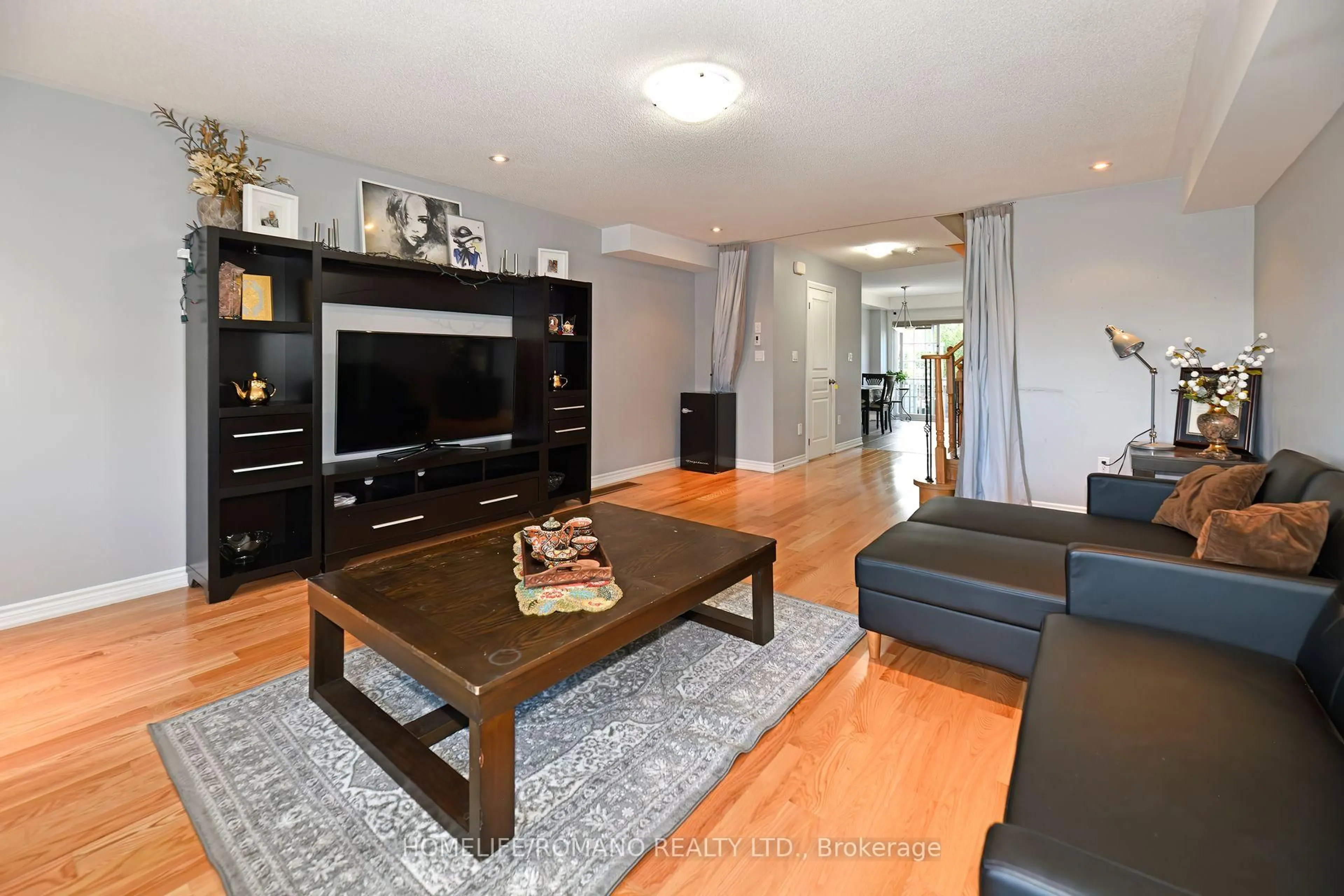Living room with furniture, wood/laminate floor for 33 Comfort Way, Whitby Ontario L1N 2K6