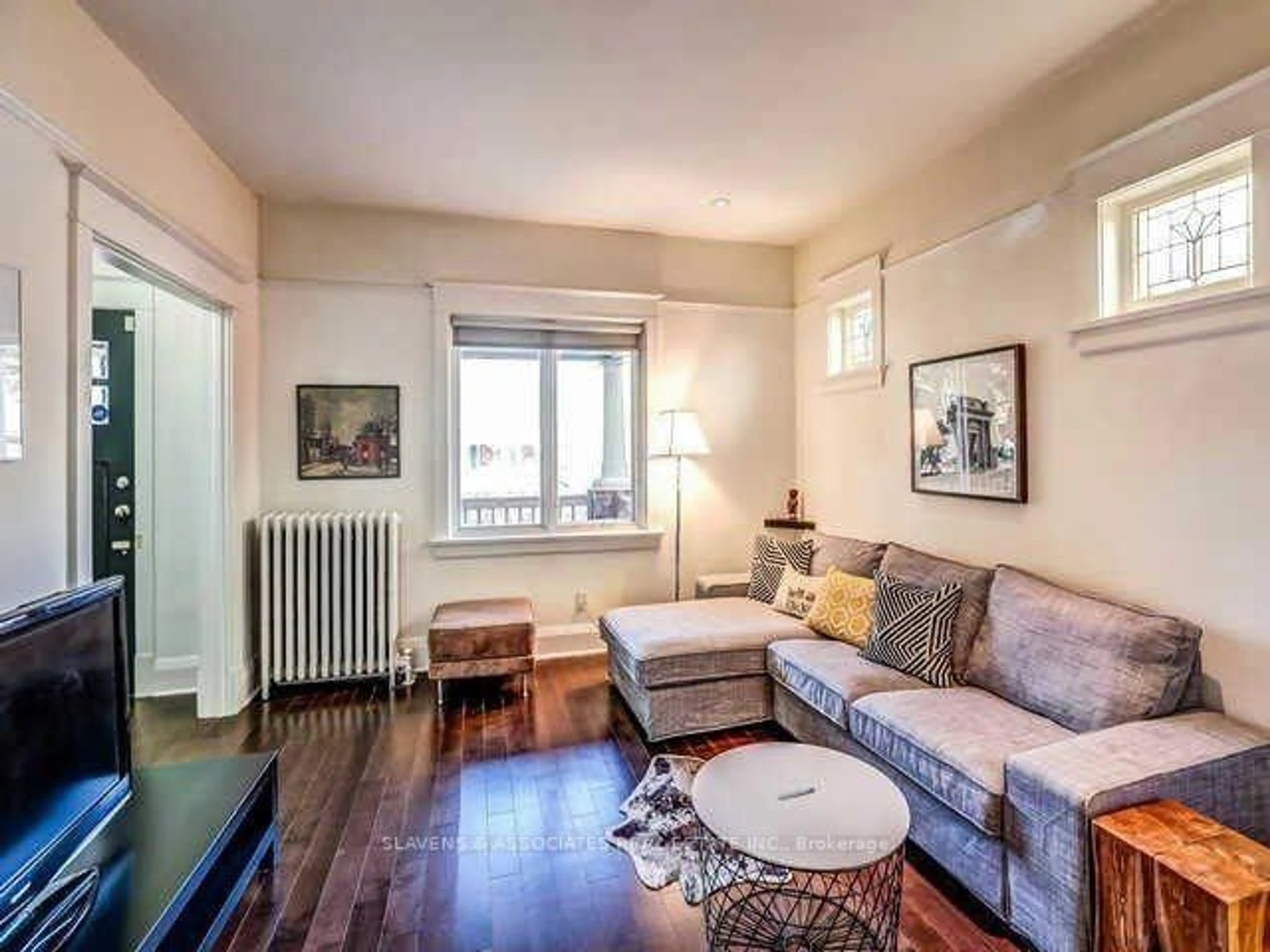 Living room with furniture, wood/laminate floor for 13 Sutherland Ave, Toronto Ontario M4C 1R8