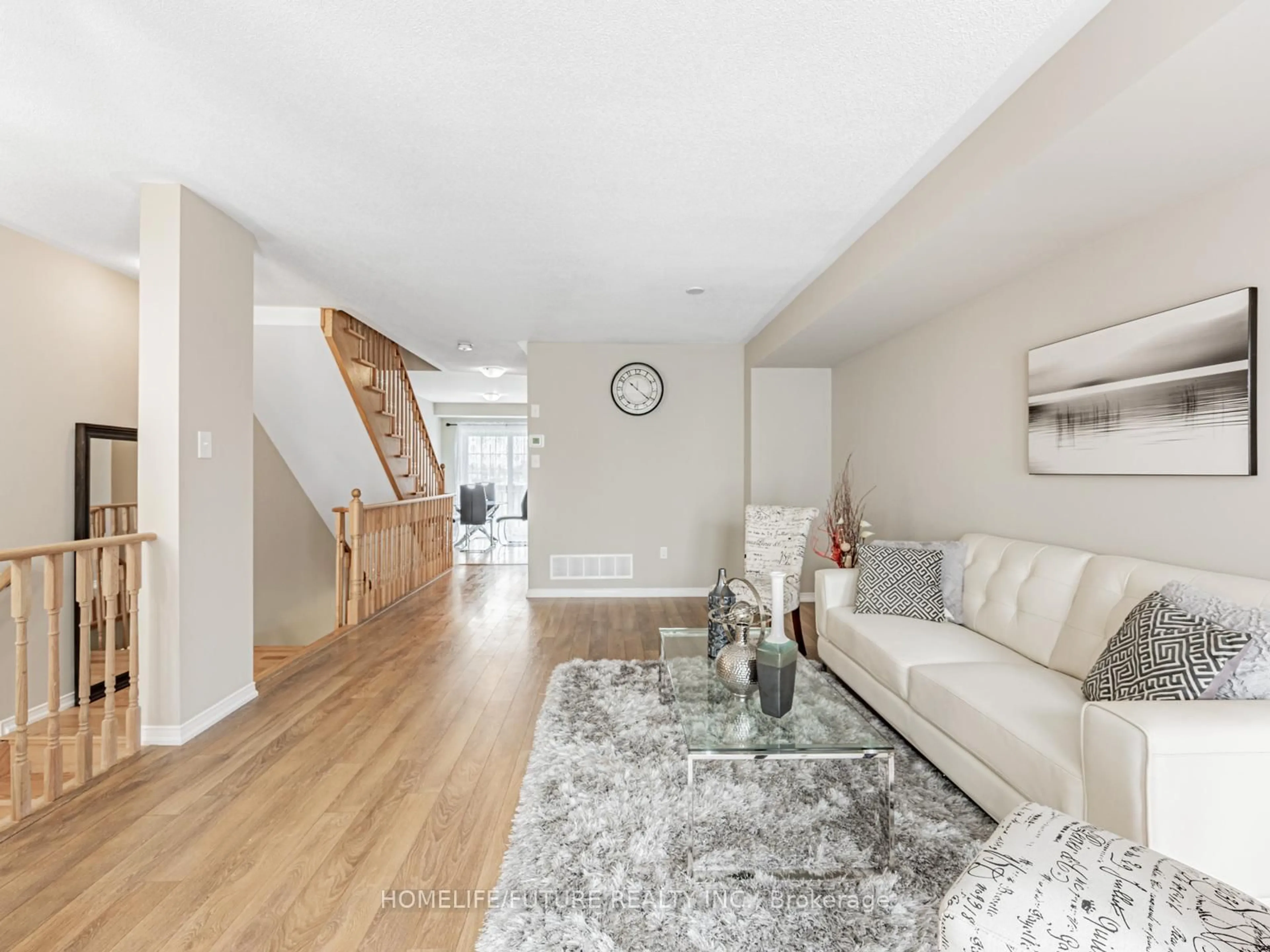 Living room with furniture, wood/laminate floor for 2611 Deputy Minister Path, Oshawa Ontario L1L 0M7