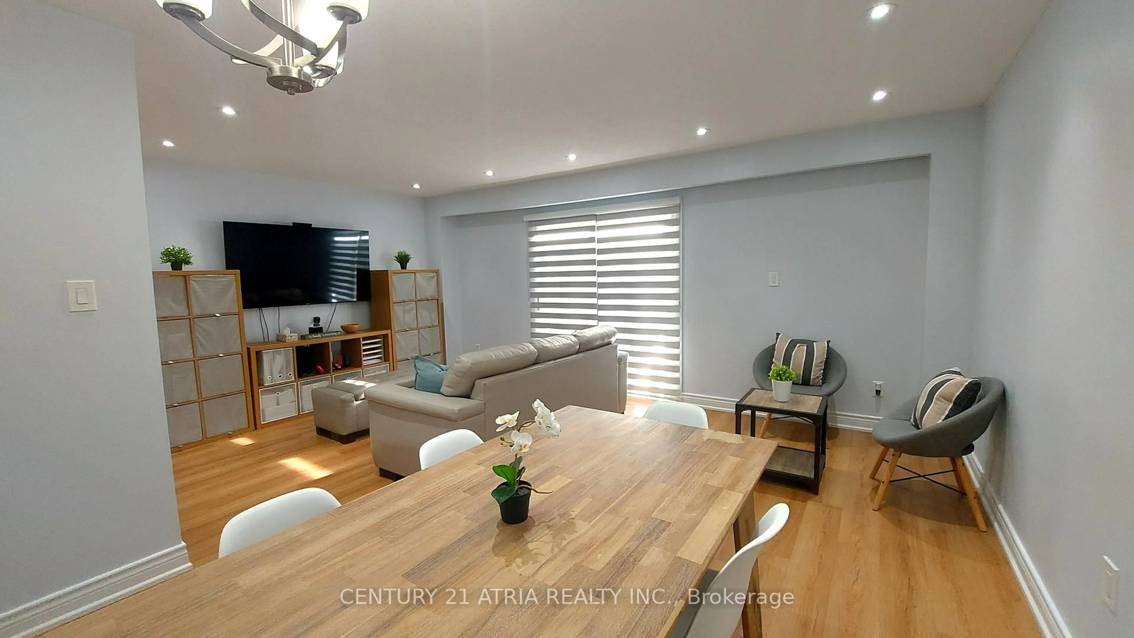 Living room with furniture, wood/laminate floor for 143 Purpledusk Tr, Toronto Ontario M1E 4C9