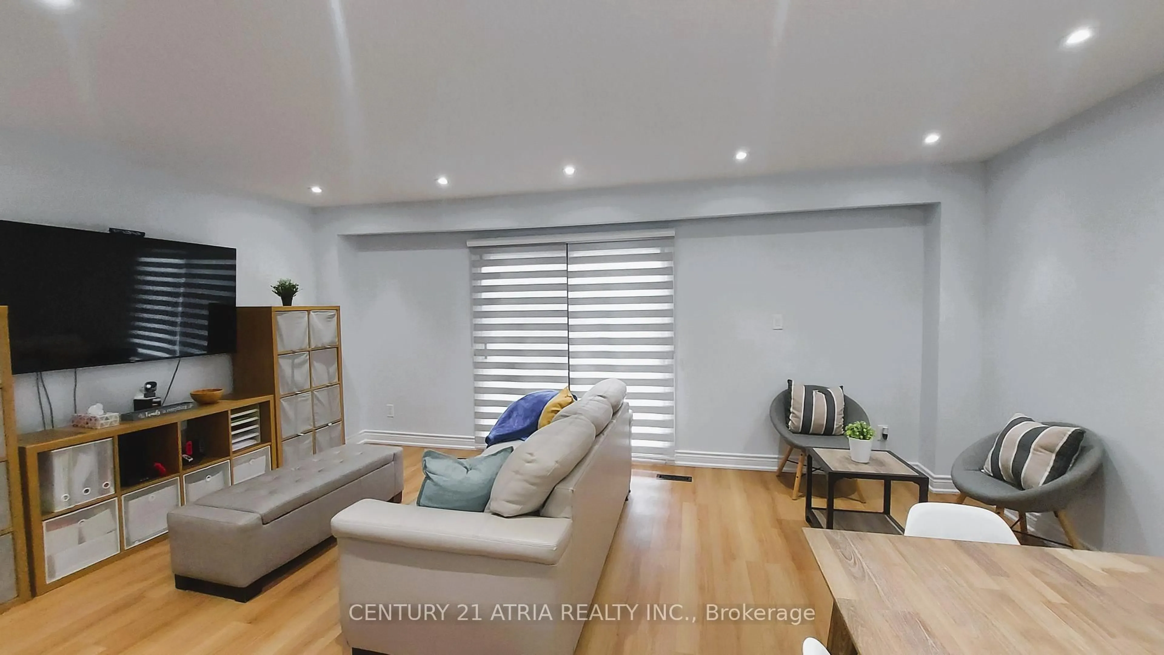 Living room with furniture, wood/laminate floor for 143 Purpledusk Tr, Toronto Ontario M1E 4C9