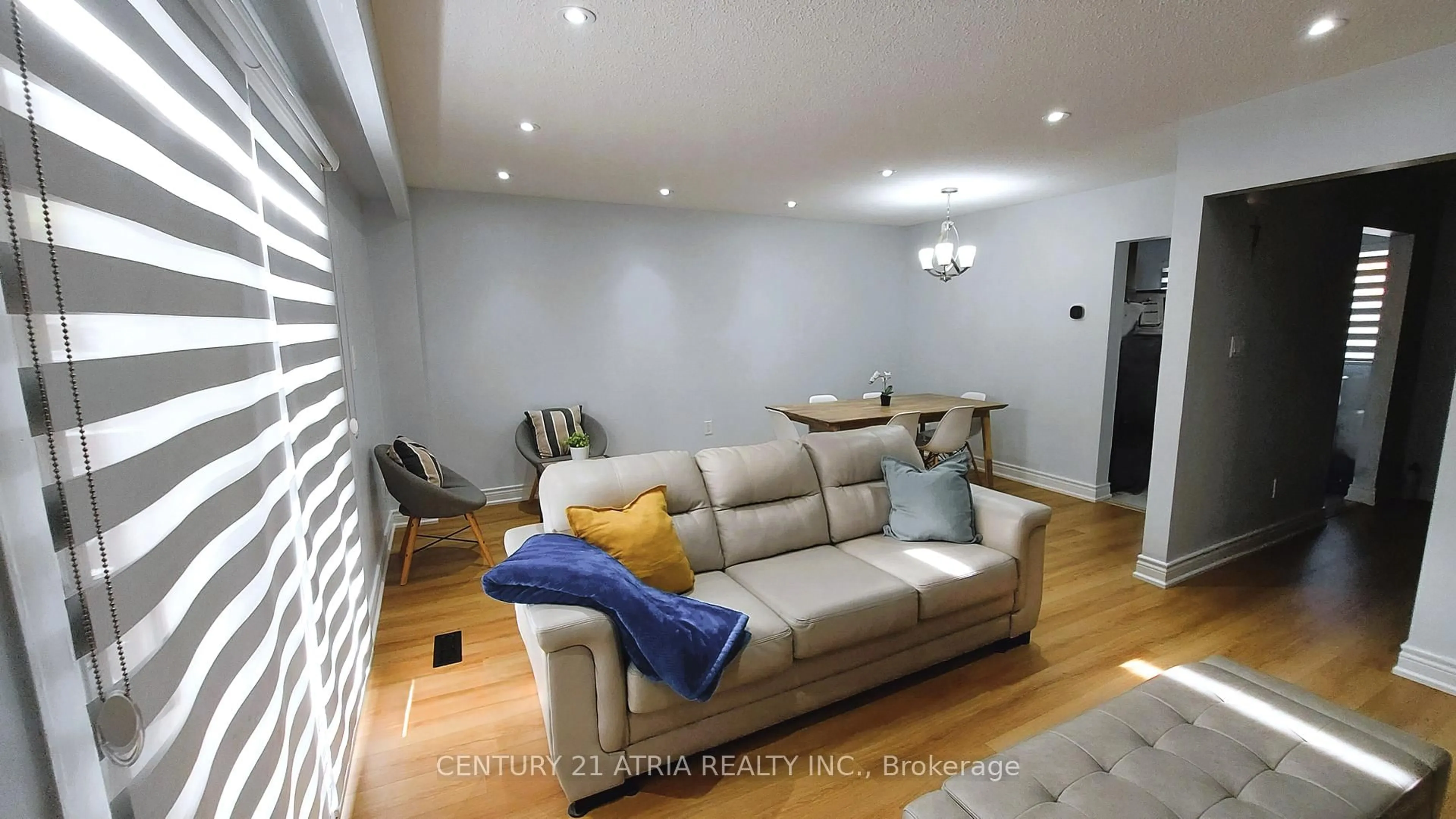 Living room with furniture, wood/laminate floor for 143 Purpledusk Tr, Toronto Ontario M1E 4C9