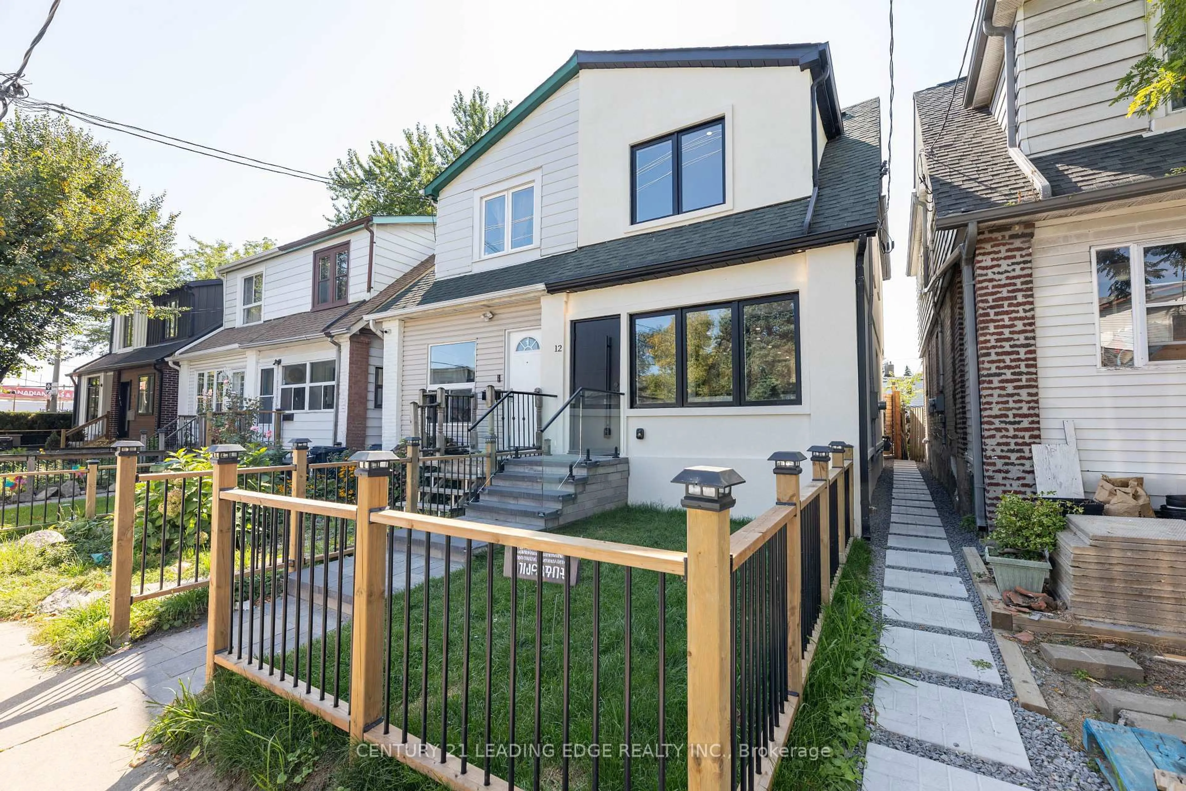 Home with vinyl exterior material, street for 12 Marigold Ave, Toronto Ontario M4M 3B2