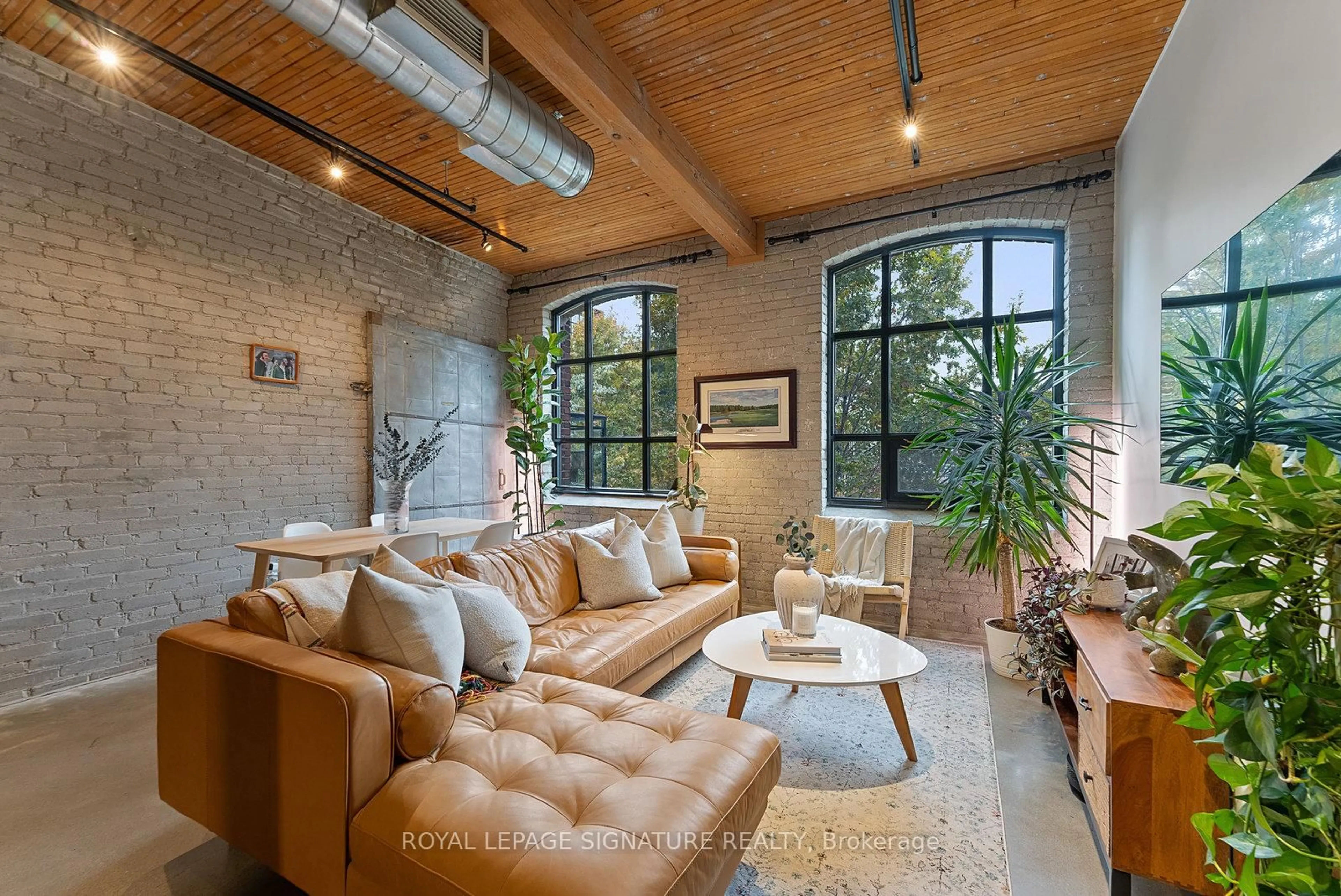 Living room with furniture, cement floor for 68 Broadview Ave #430, Toronto Ontario M4M 2E6