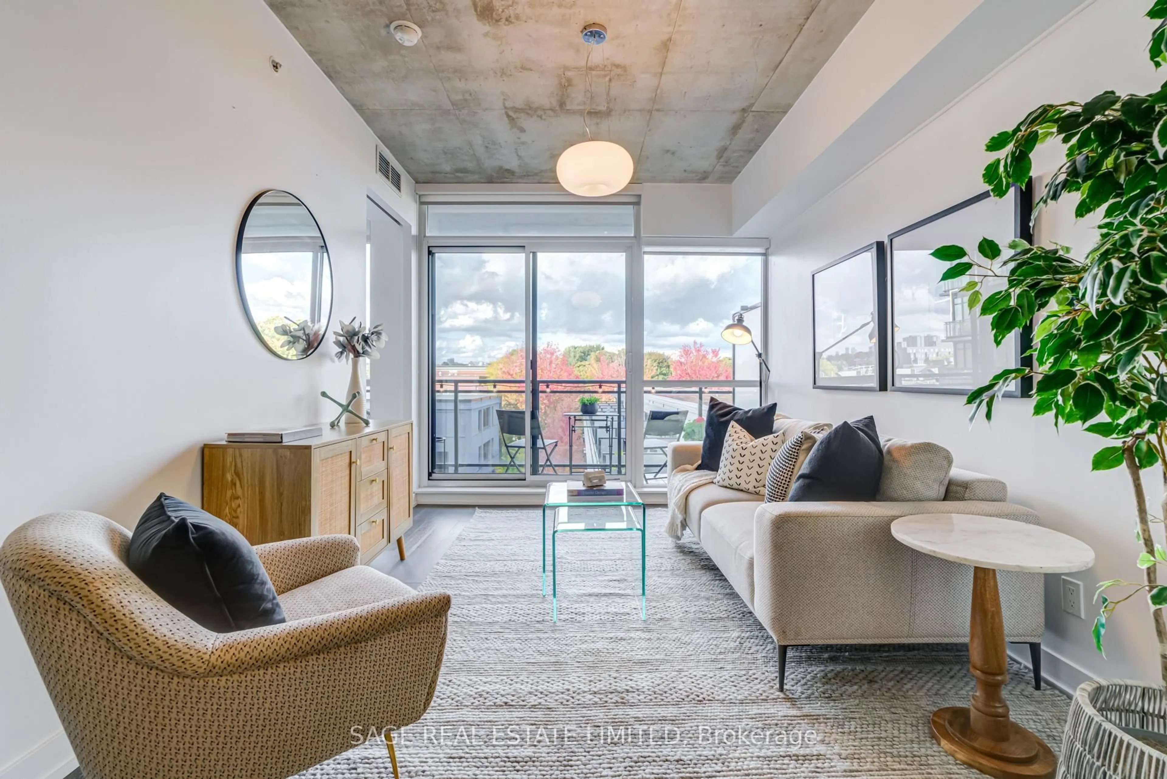 Living room with furniture, cement floor for 1190 Dundas St #504, Toronto Ontario M4M 0C5