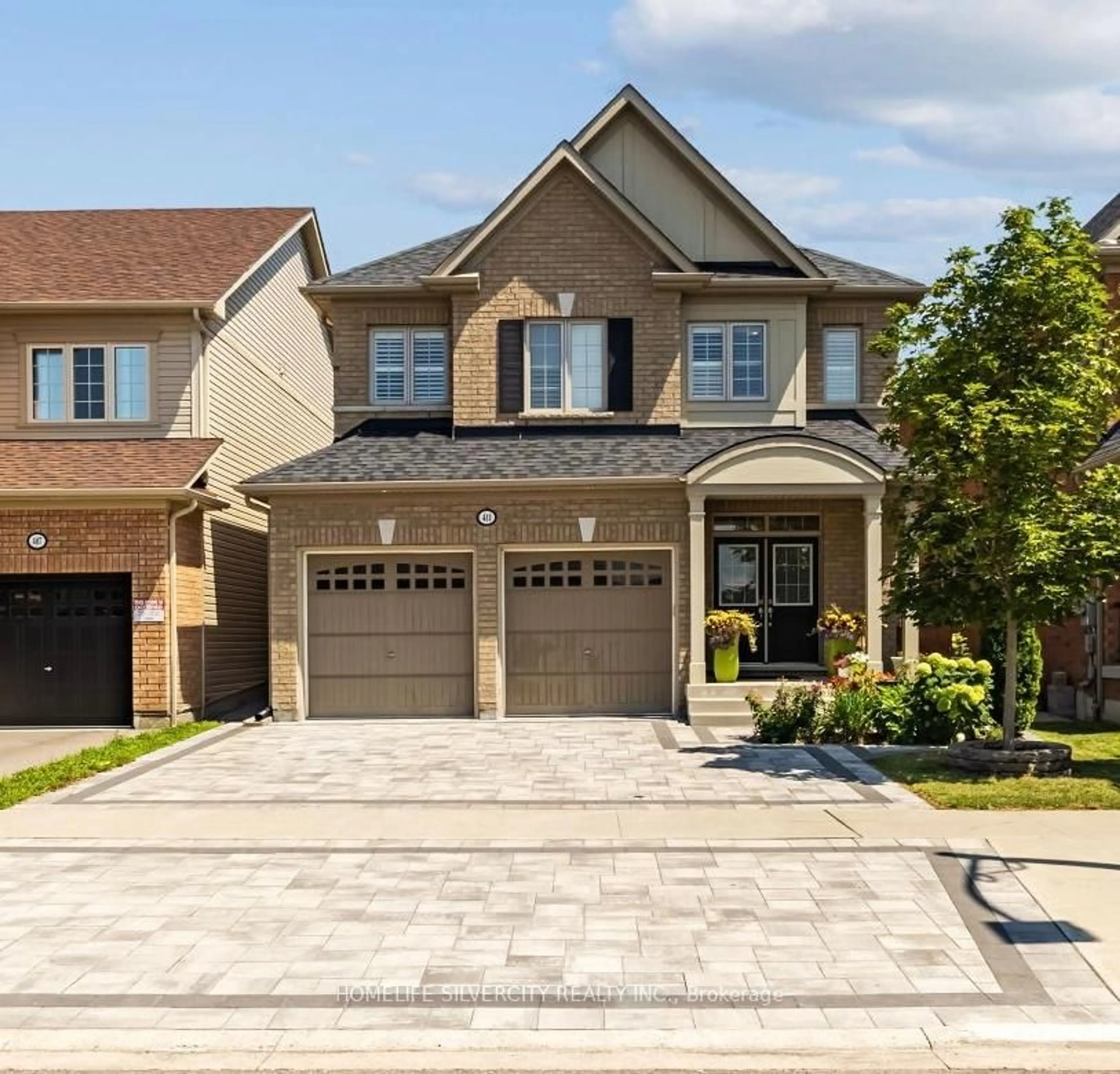 Home with brick exterior material, street for 411 Windfields Farm Dr, Oshawa Ontario L1L 0M1