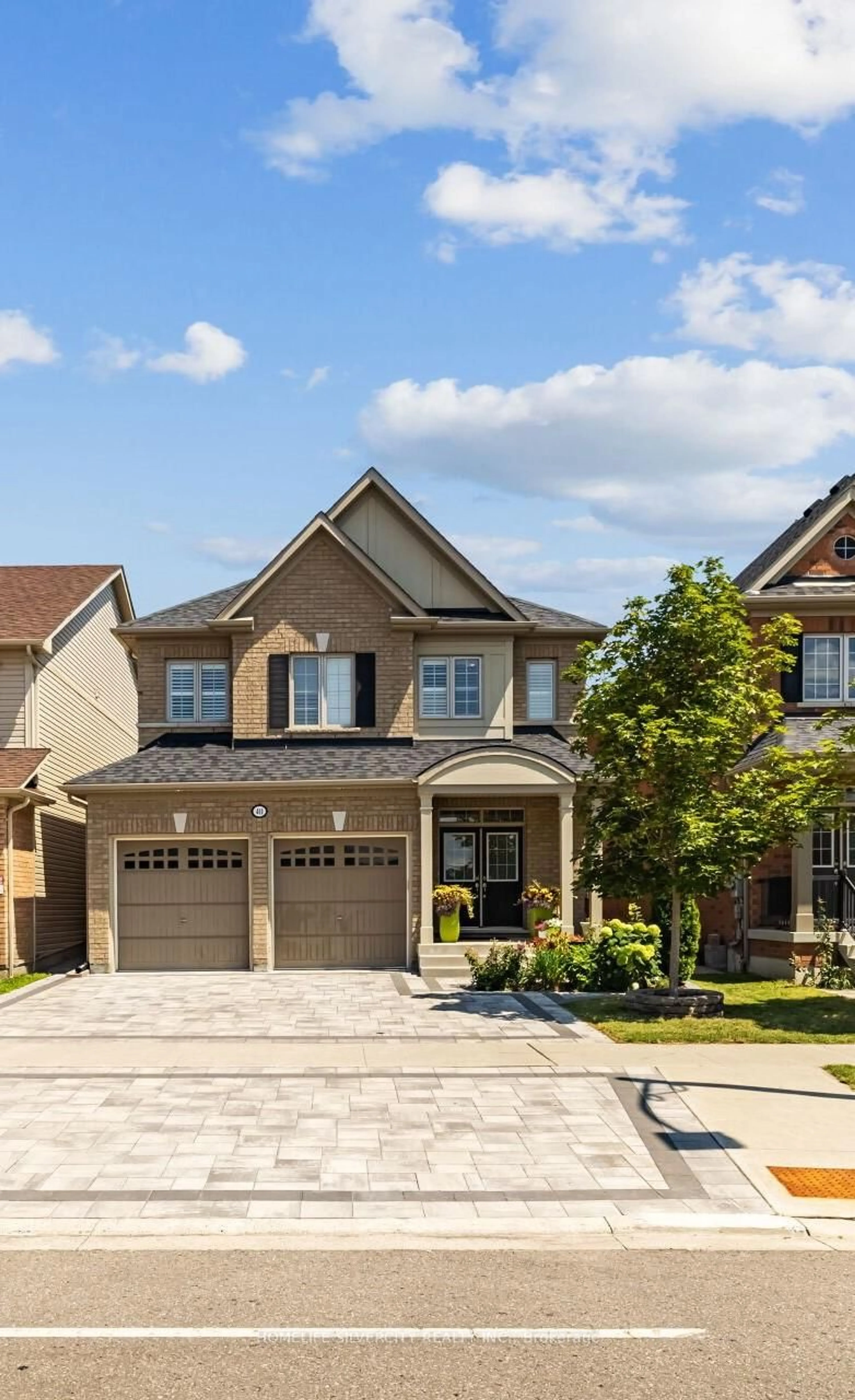 Home with brick exterior material, street for 411 Windfields Farm Dr, Oshawa Ontario L1L 0M1