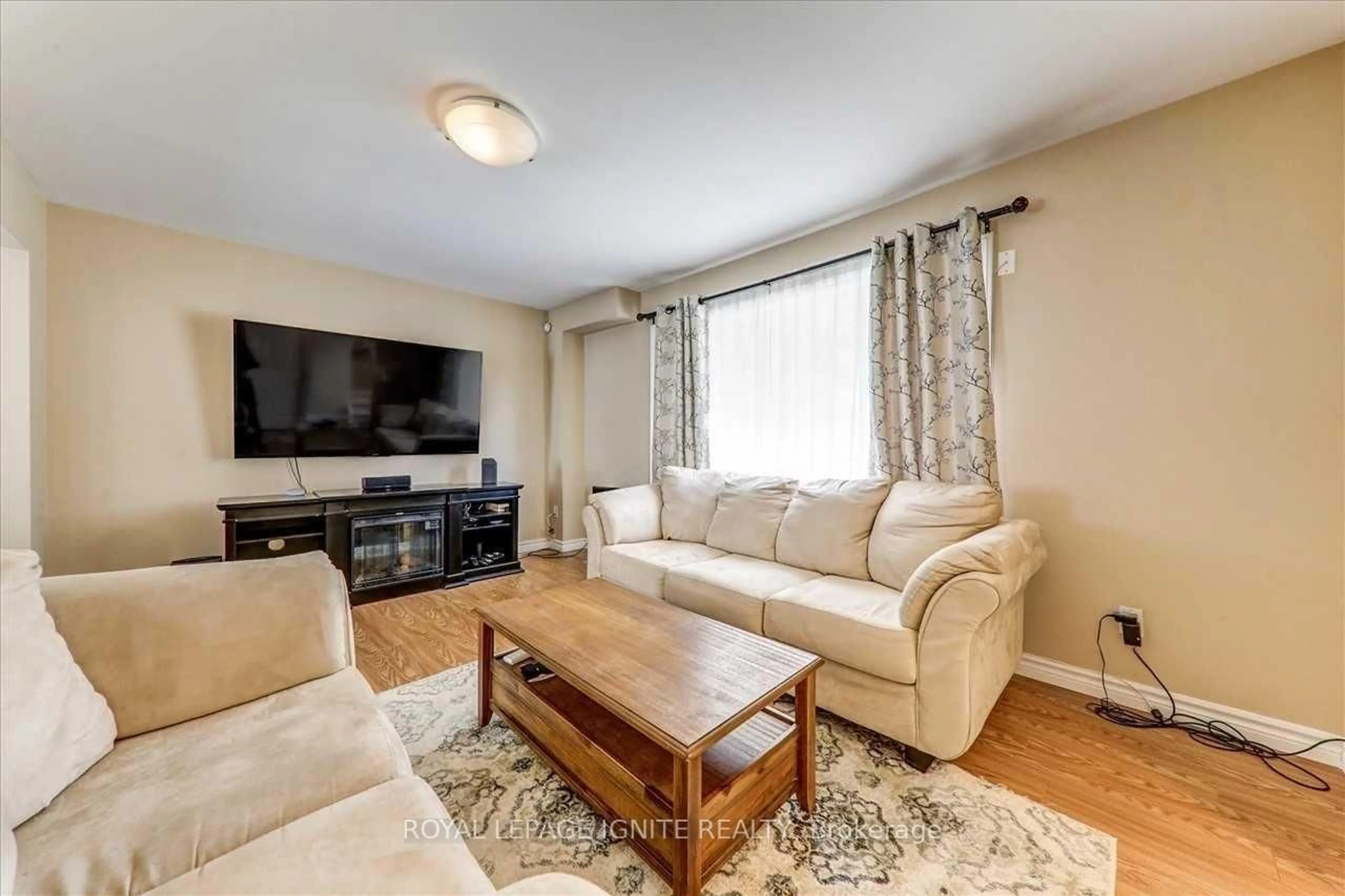 Living room with furniture, wood/laminate floor for 111 Dunsfold Dr, Toronto Ontario M1B 1T5