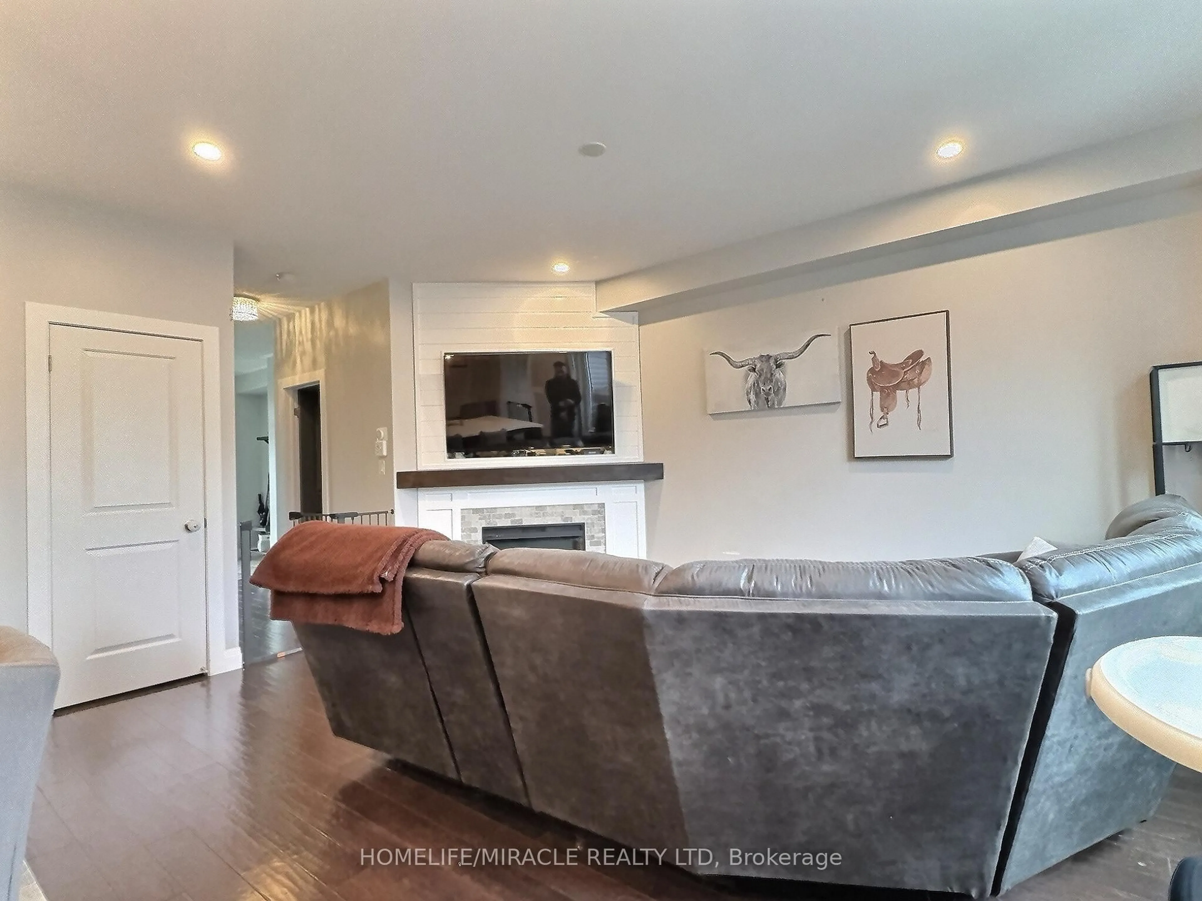 Living room with furniture, wood/laminate floor for 50 Murray Tabb St, Clarington Ontario L1C 3K7