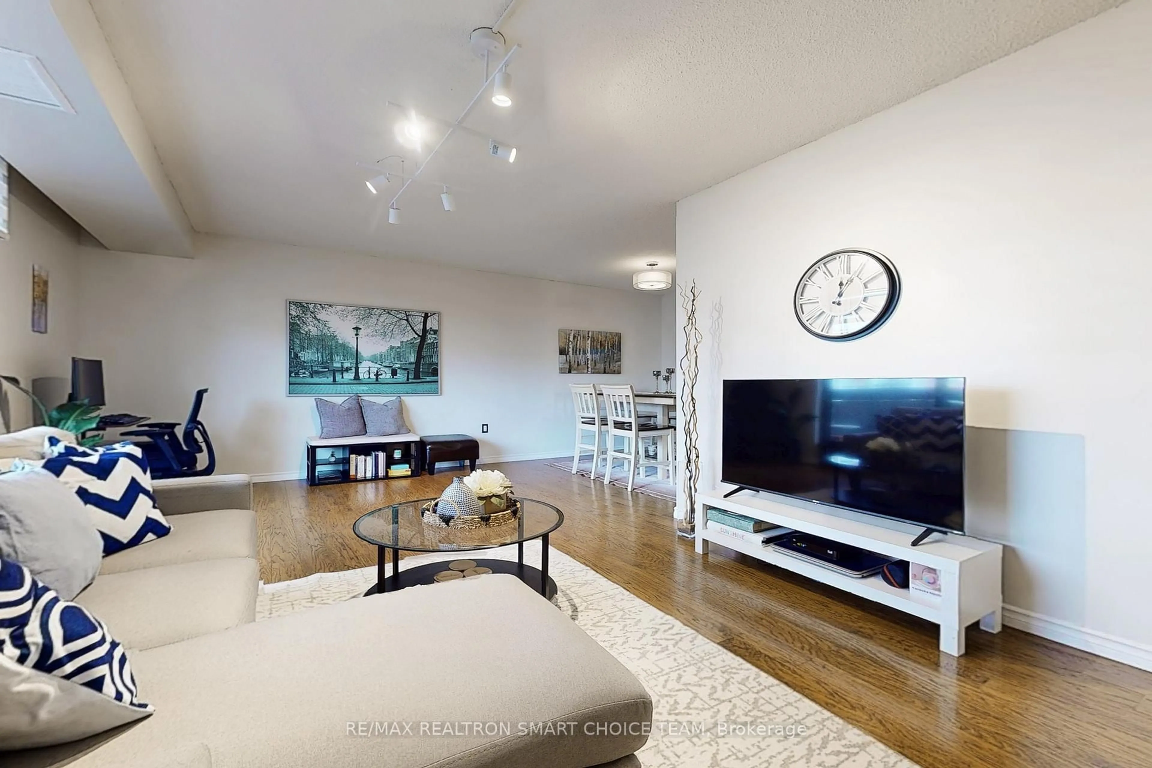 Living room with furniture, wood/laminate floor for 1200 Bridletowne Circ #507, Toronto Ontario M1W 2H8