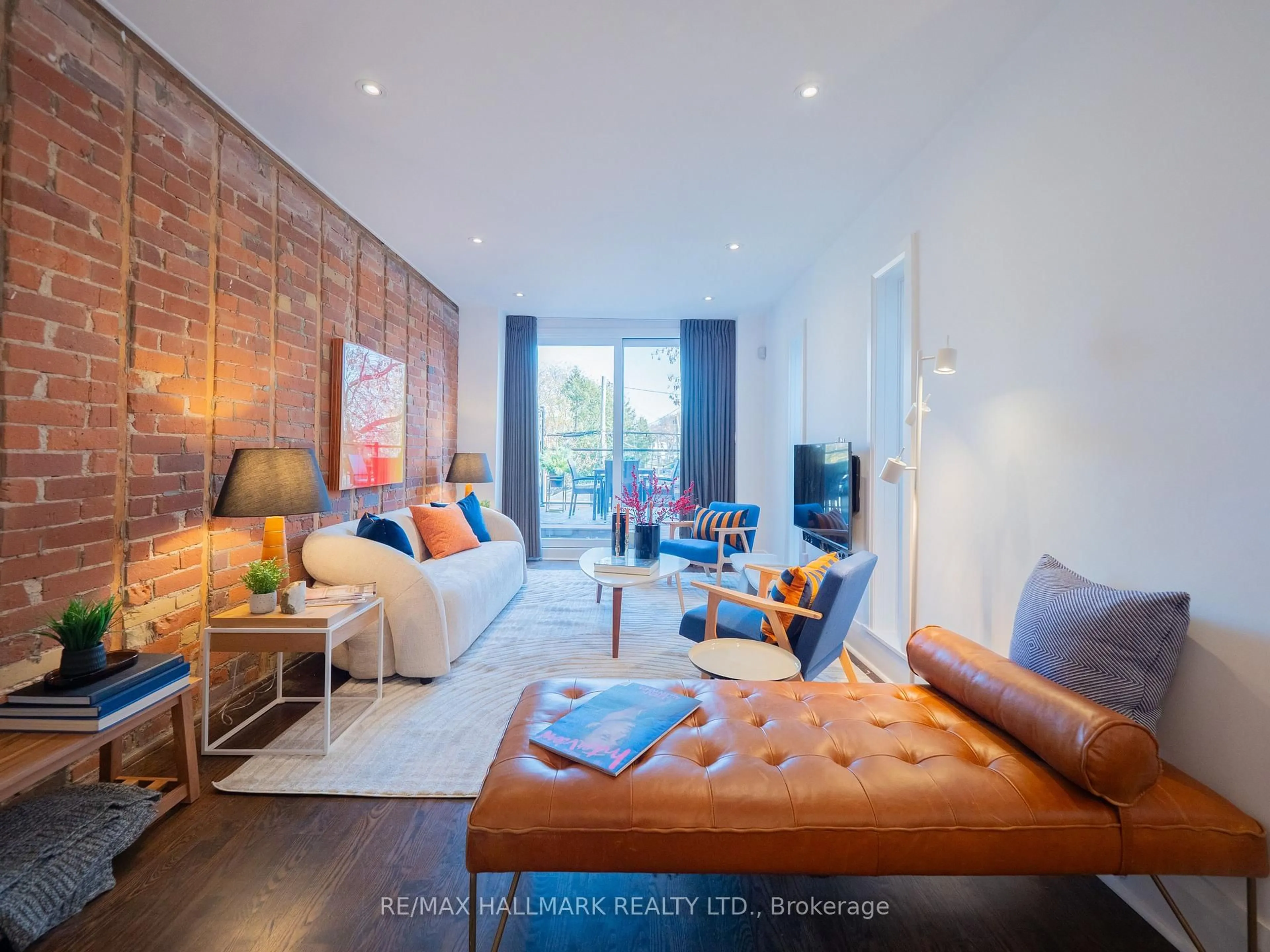 Living room with furniture, wood/laminate floor for 559 Logan Ave, Toronto Ontario M4K 3B6