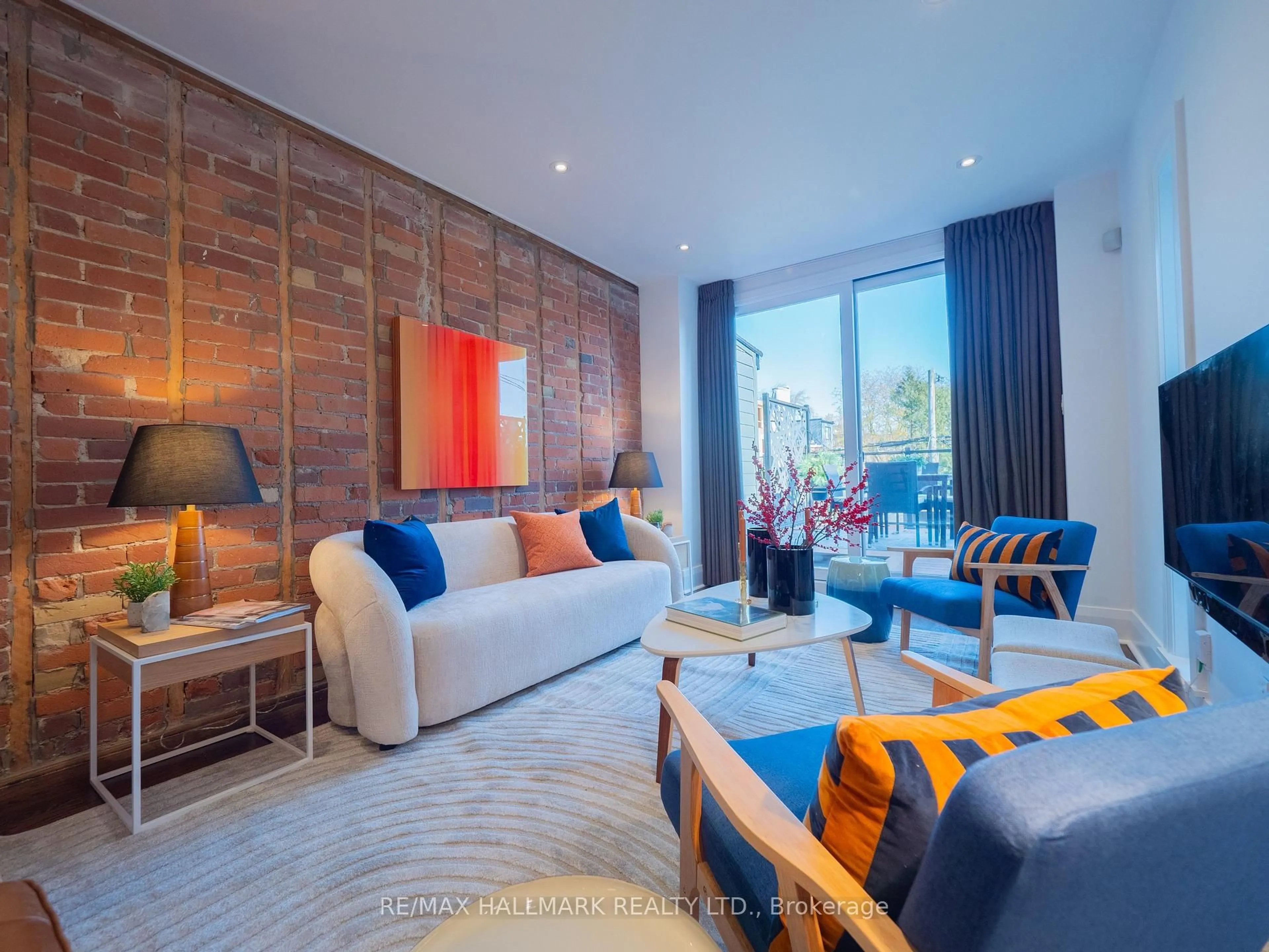 Living room with furniture, wood/laminate floor for 559 Logan Ave, Toronto Ontario M4K 3B6