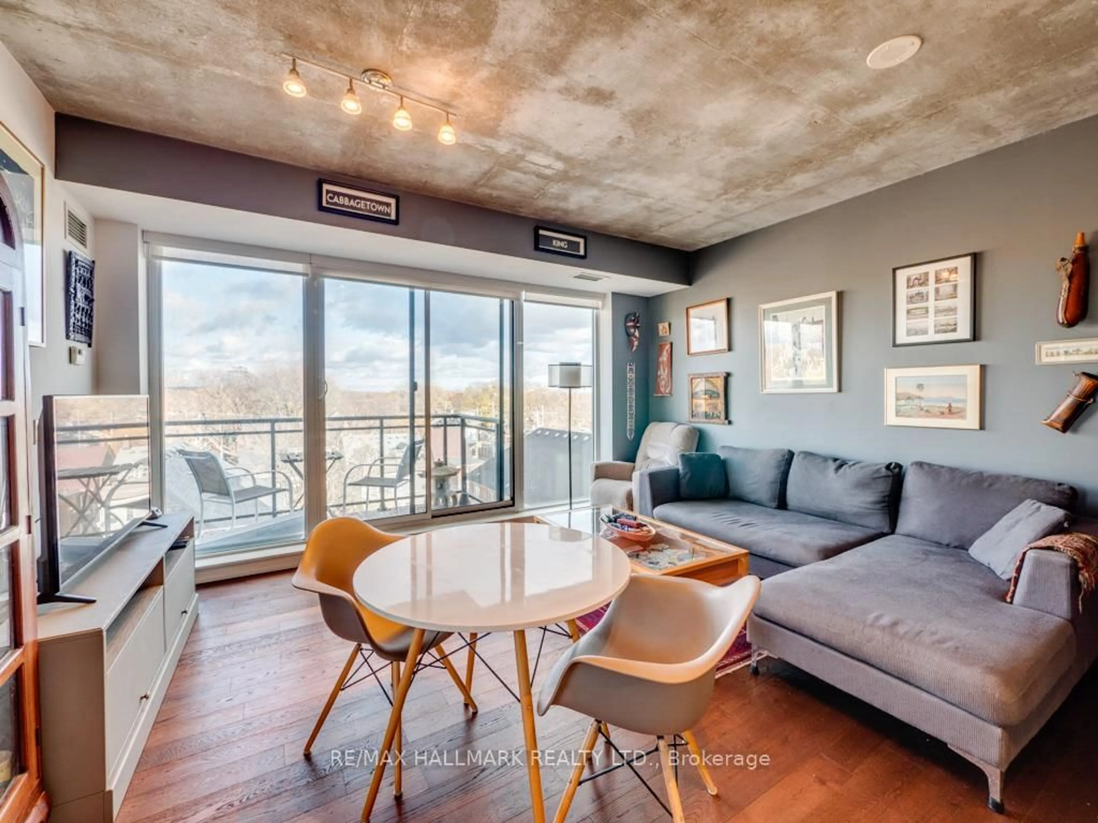 Living room with furniture, cement floor for 1238 Dundas St #602, Toronto Ontario M4M 0C6